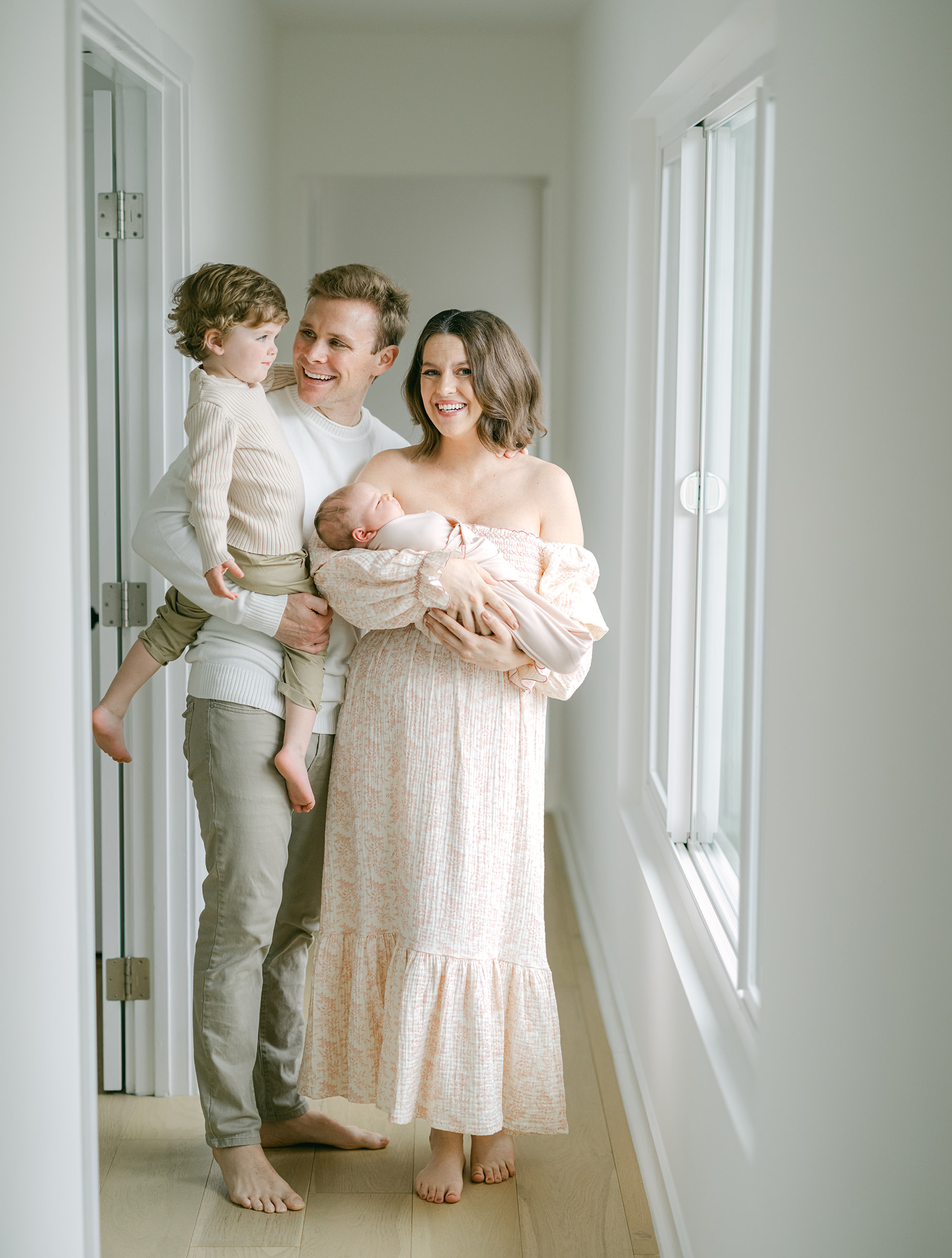 Young family poses for an in home newborn session. 