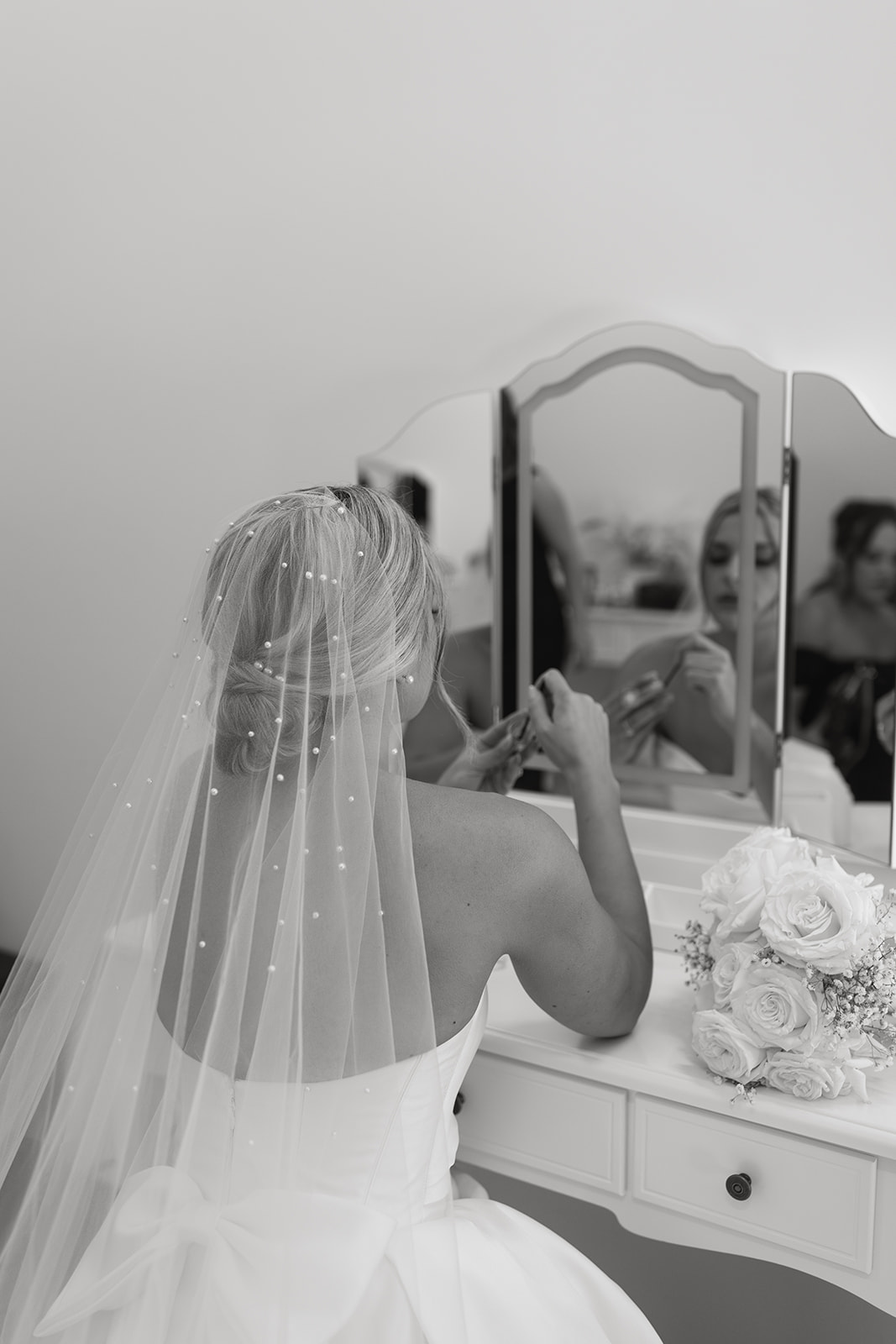 hangar 21 wedding fullerton california bride getting ready pictures bride sitting in front of a mirror bridal veil tulle