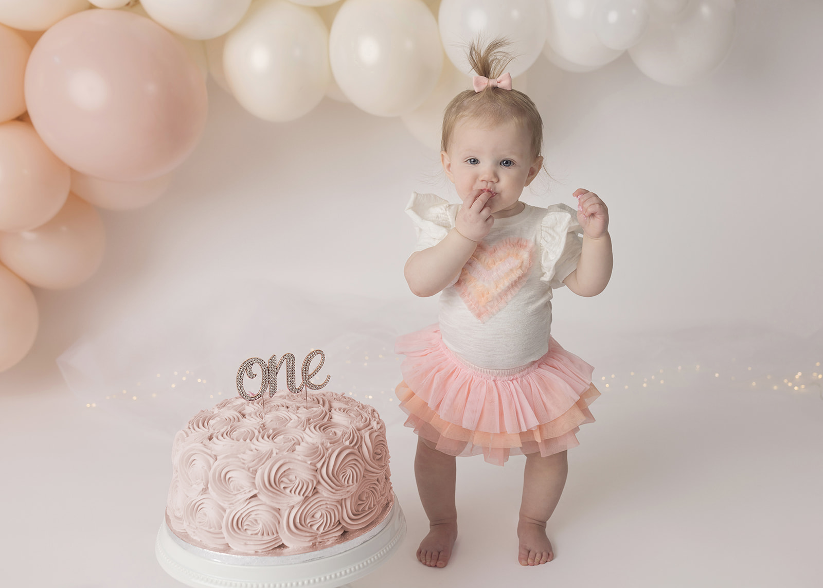 1st birthday girl cake smash photo shoot eating cake