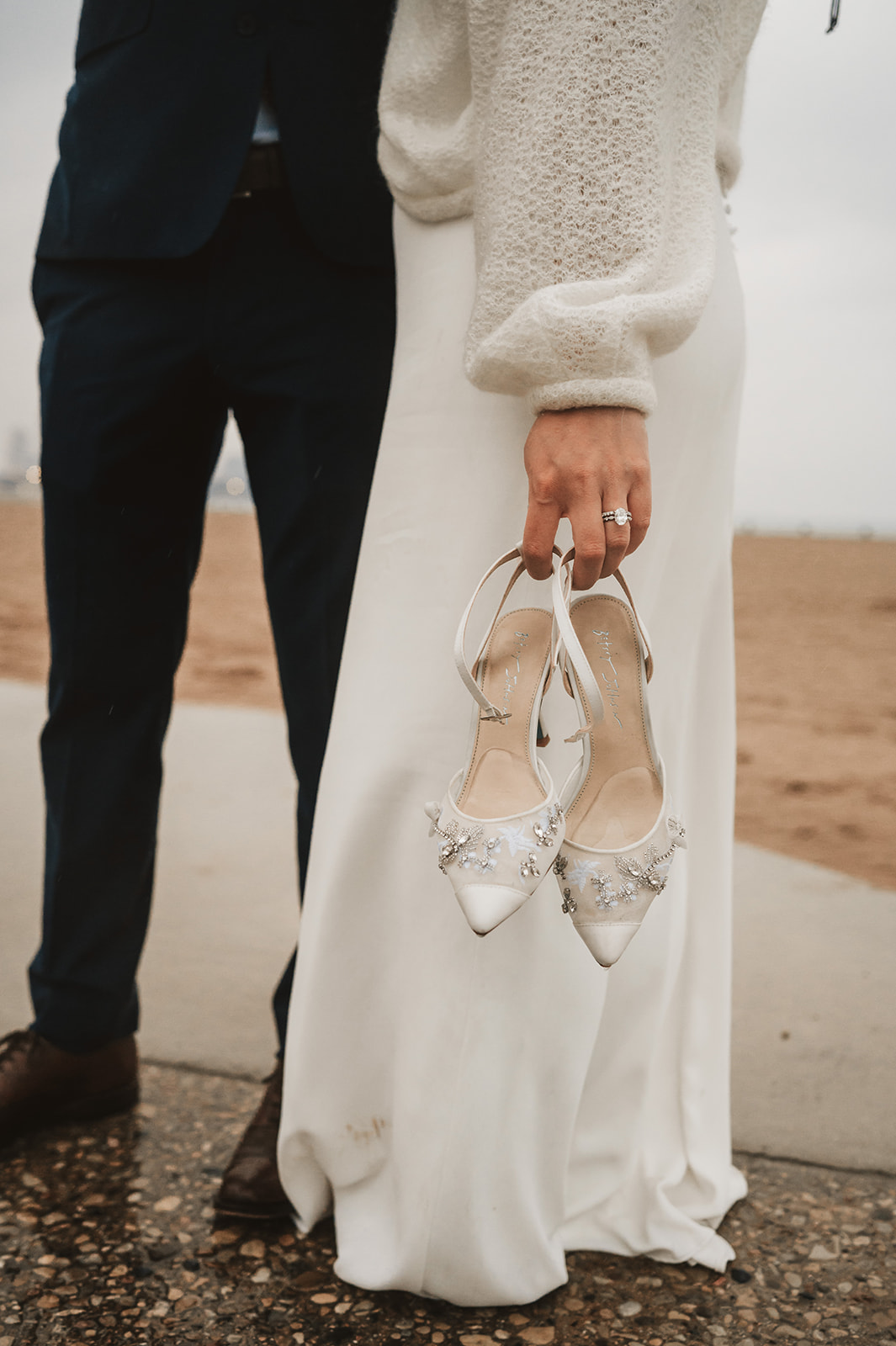 Intimate rainy day Chicago elopement wedding photography - barefoot bride in rain holding shoes
