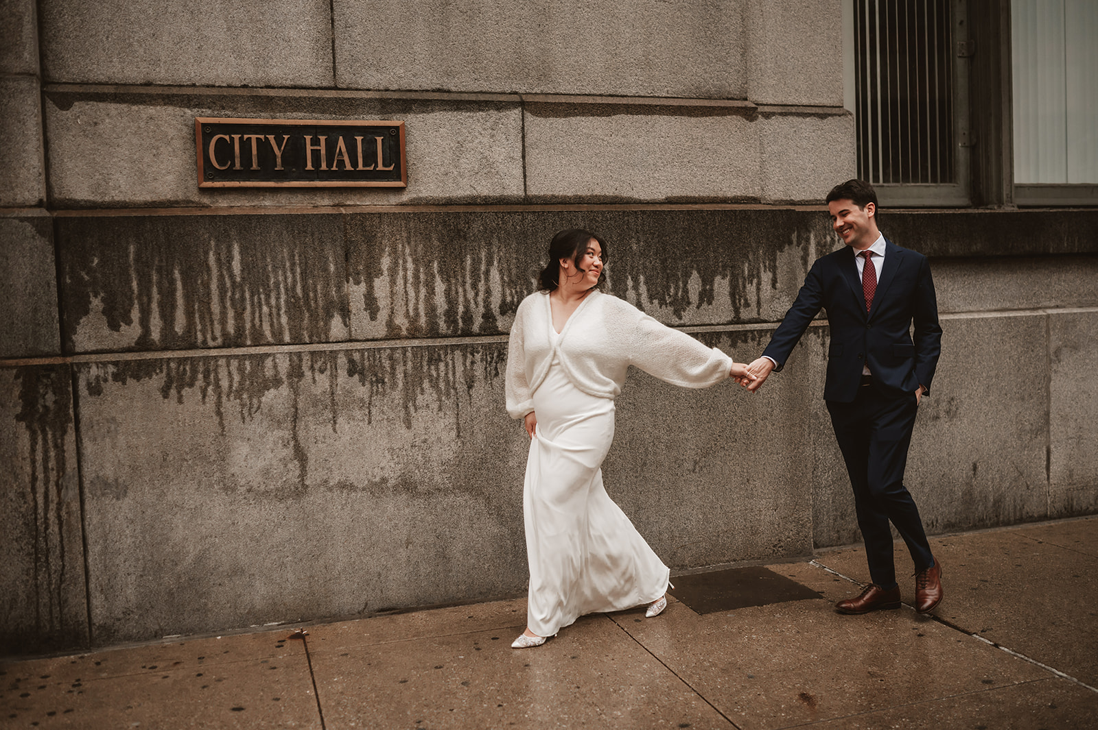 Intimate rainy day Chicago elopement wedding photography - in front of the city hall sign