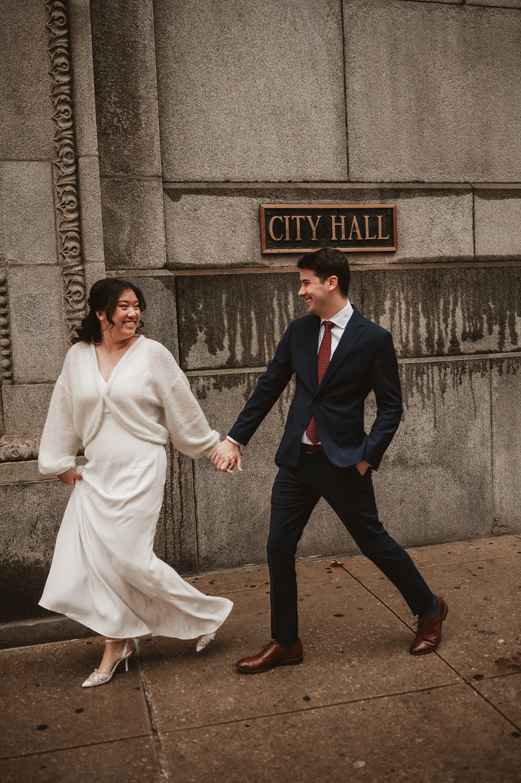 Intimate rainy day Chicago elopement wedding photography - in front of the city hall sign