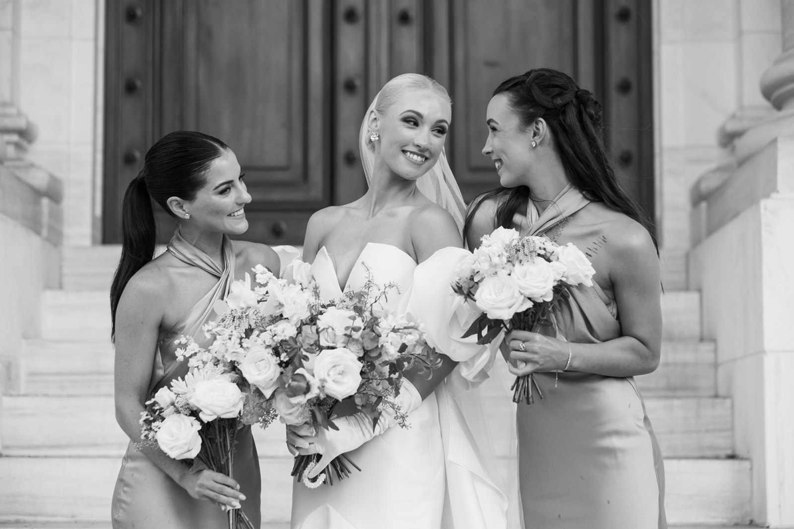 Bride laughing with sister and bridesmaid