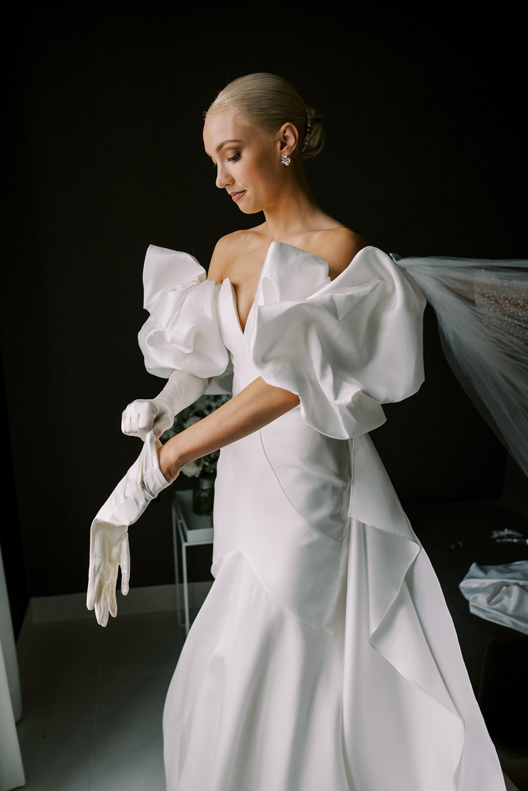 Bride puts on elegant gloves while getting ready at the Hotel Washington