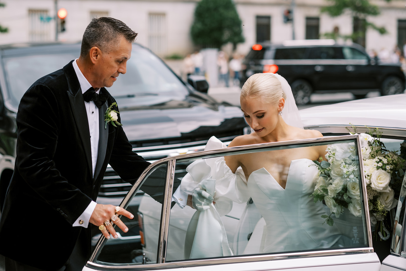 Bride's Dad helps her get into classic Rolls Royce at Hotel Washington
