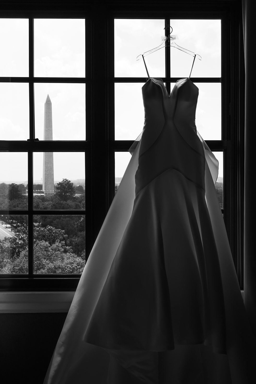 Bride's dress in the window at the Hotel Washington with Washington Monument in background