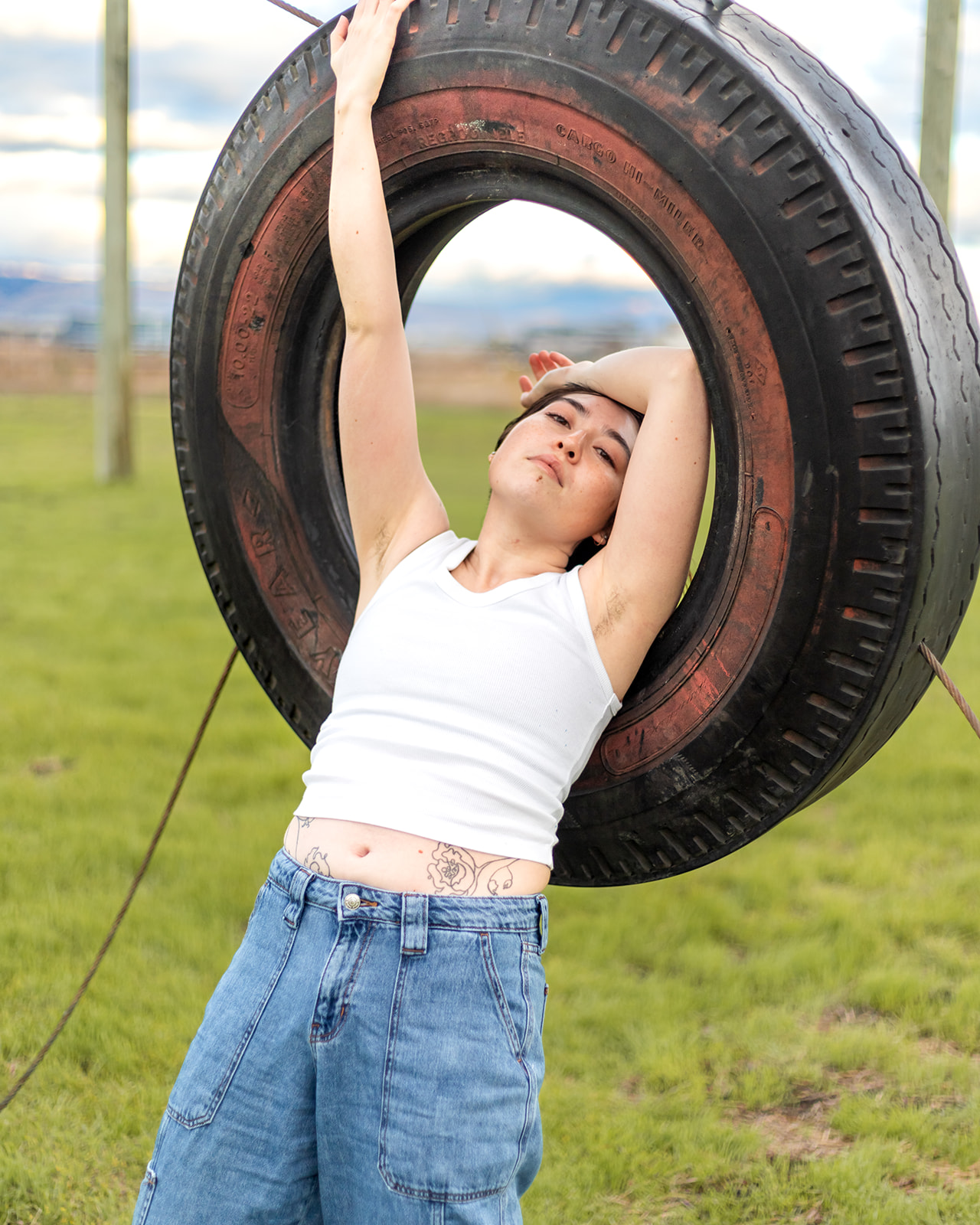 editorial photo of genderfluid person and old tire