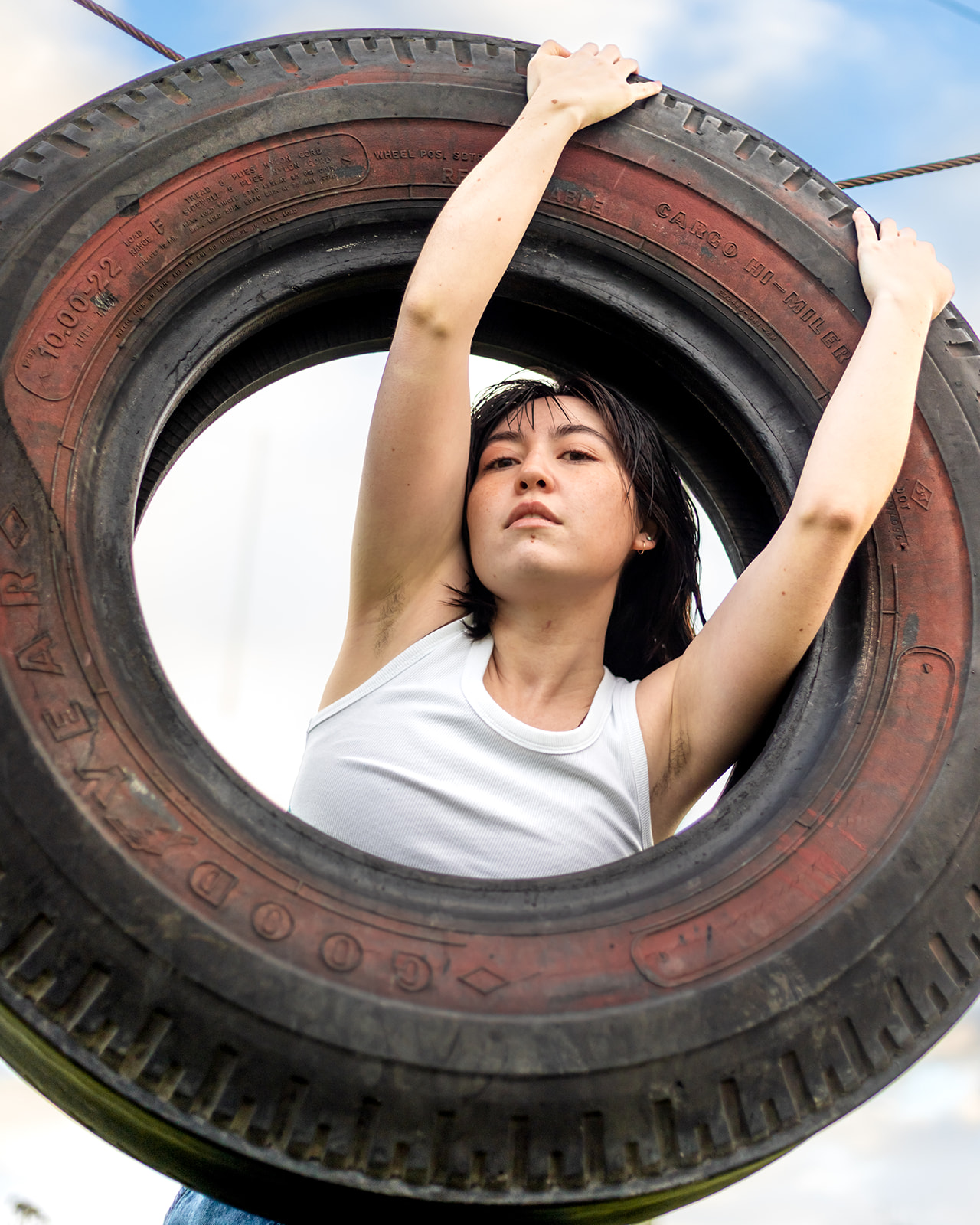 editorial photo of nonbinary person with old tire