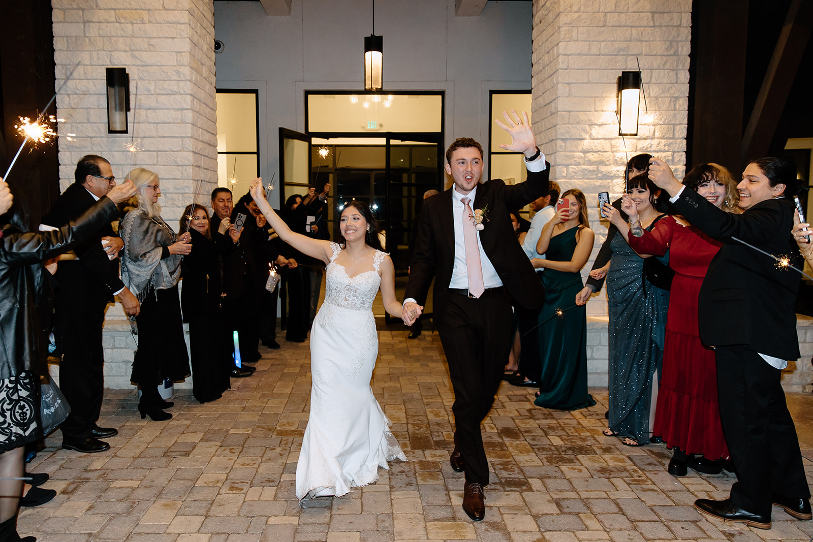 Bride and groom walking through sparklers