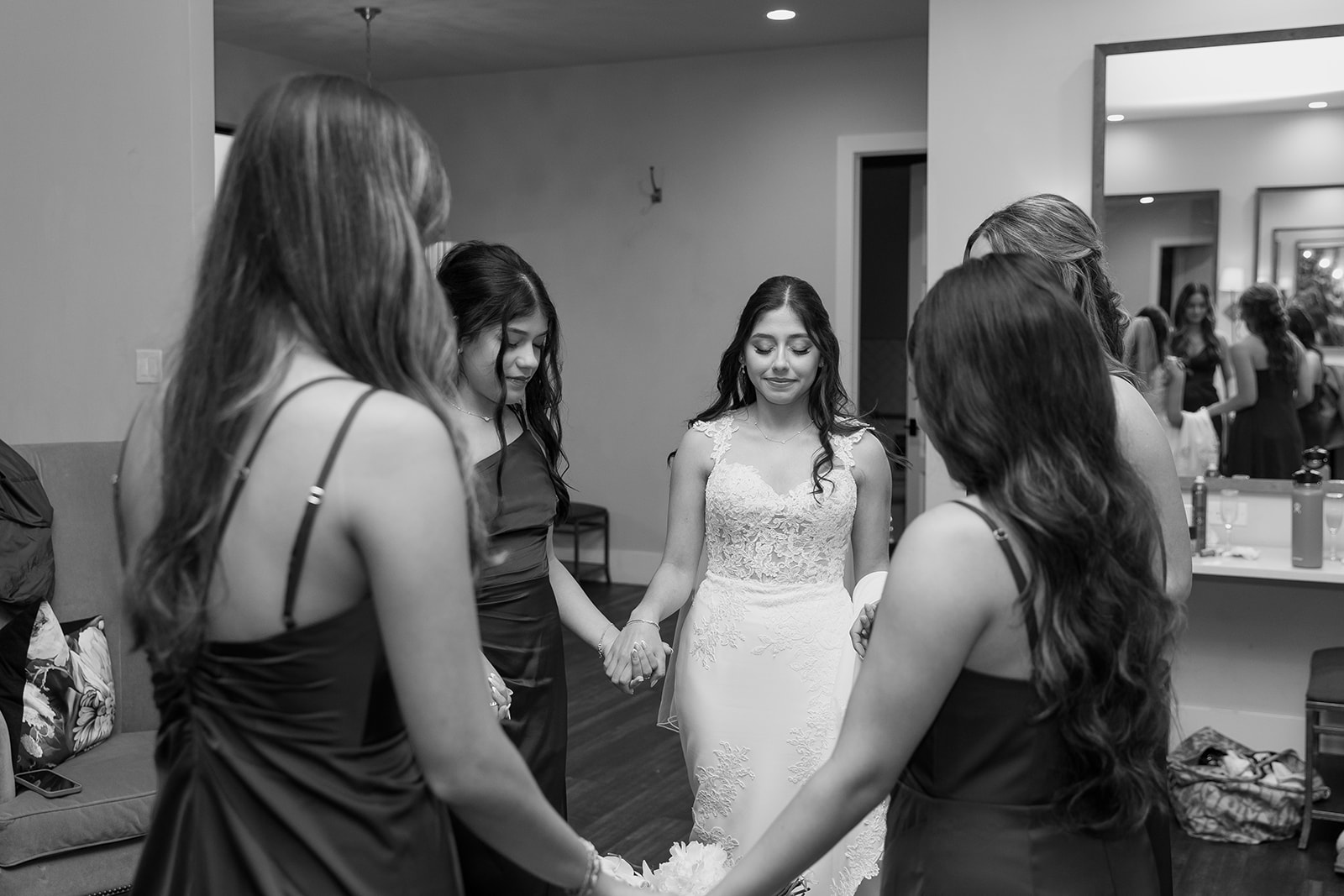 Bride and her bridesmaids praying before the ceremony