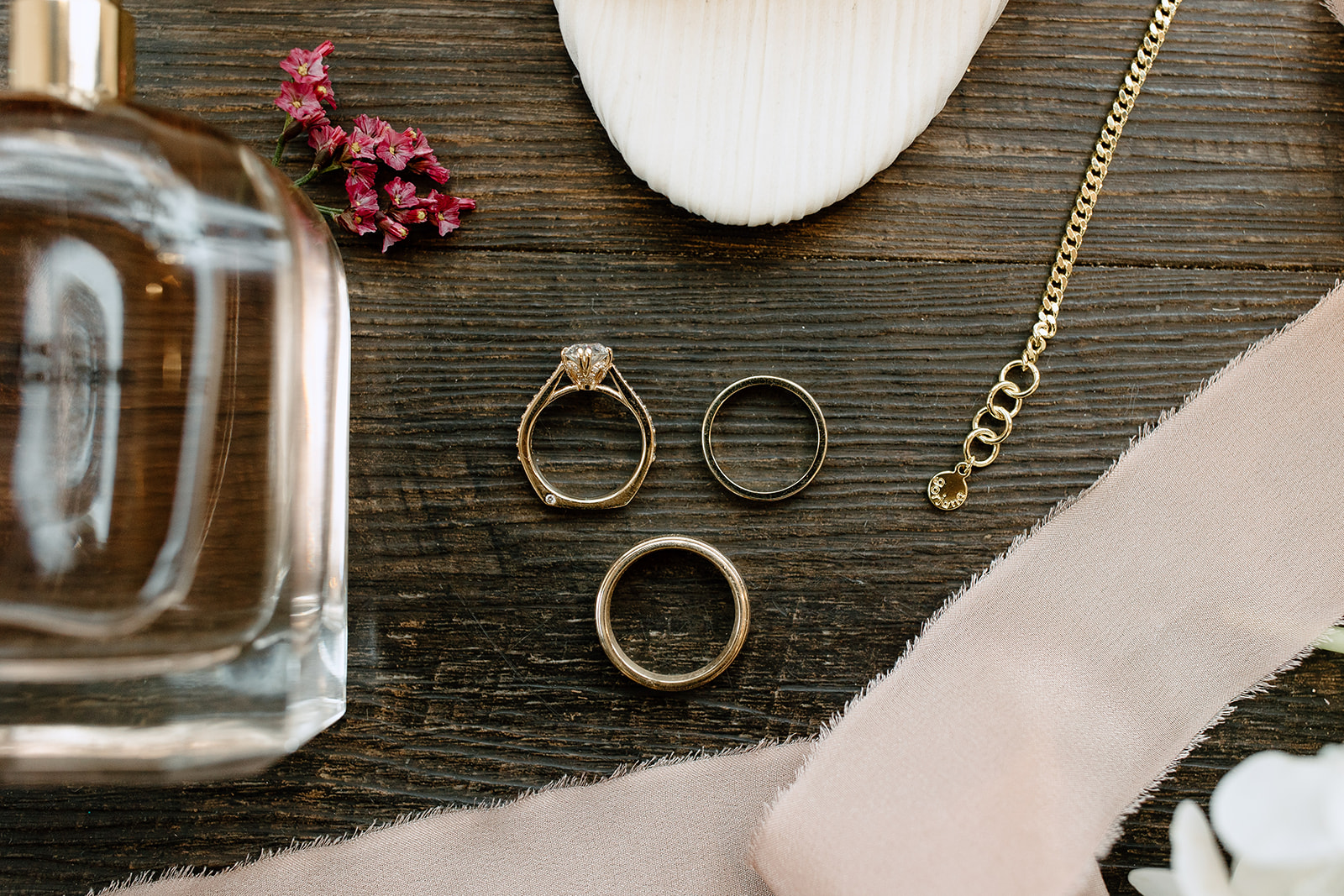 Flat lay of jewelry, shoes, and florals