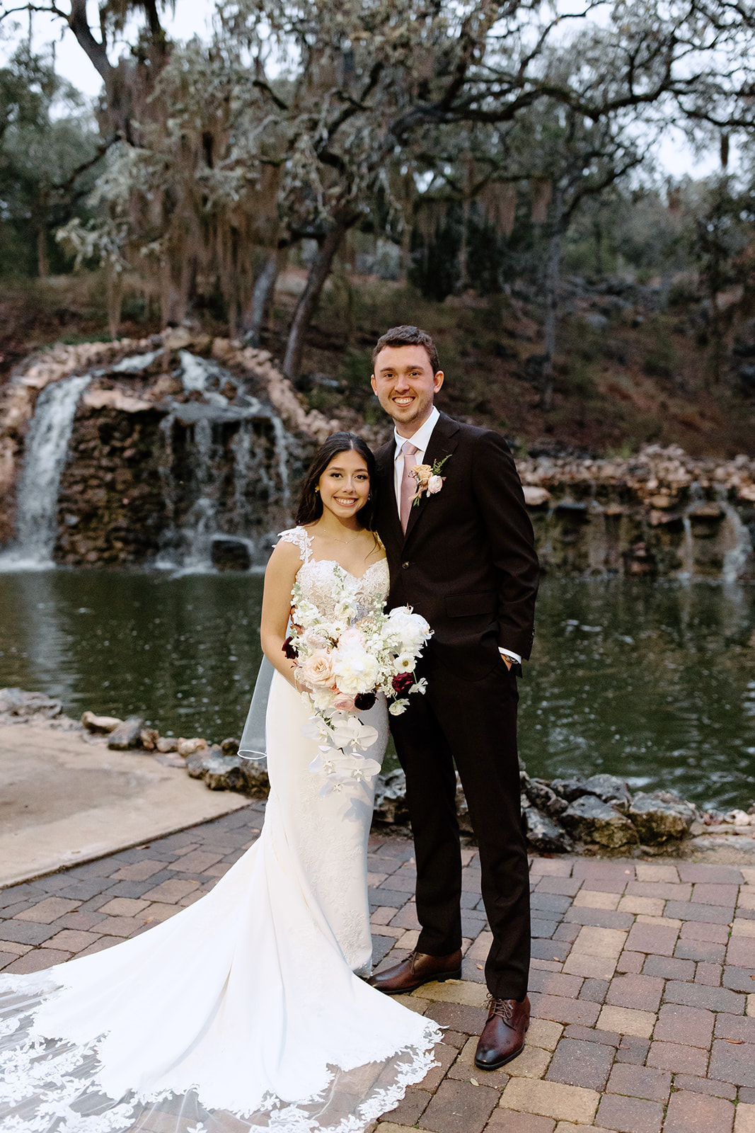Bride and groom in front of a waterfall