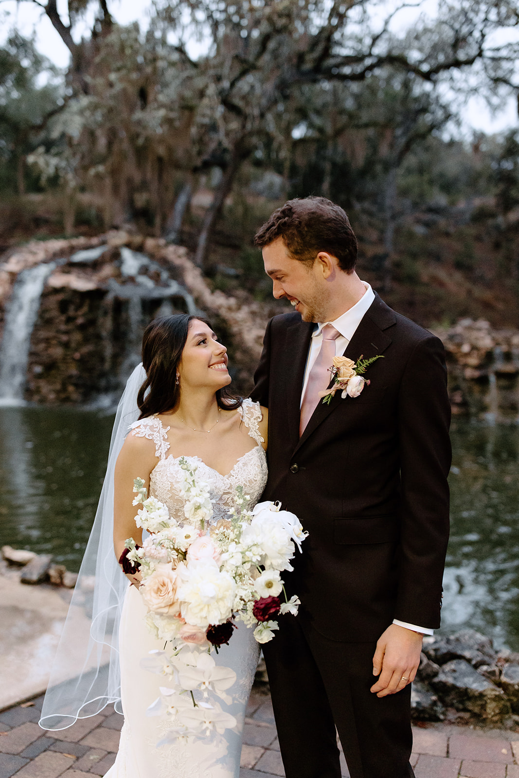 Bride and groom in front of a waterfall