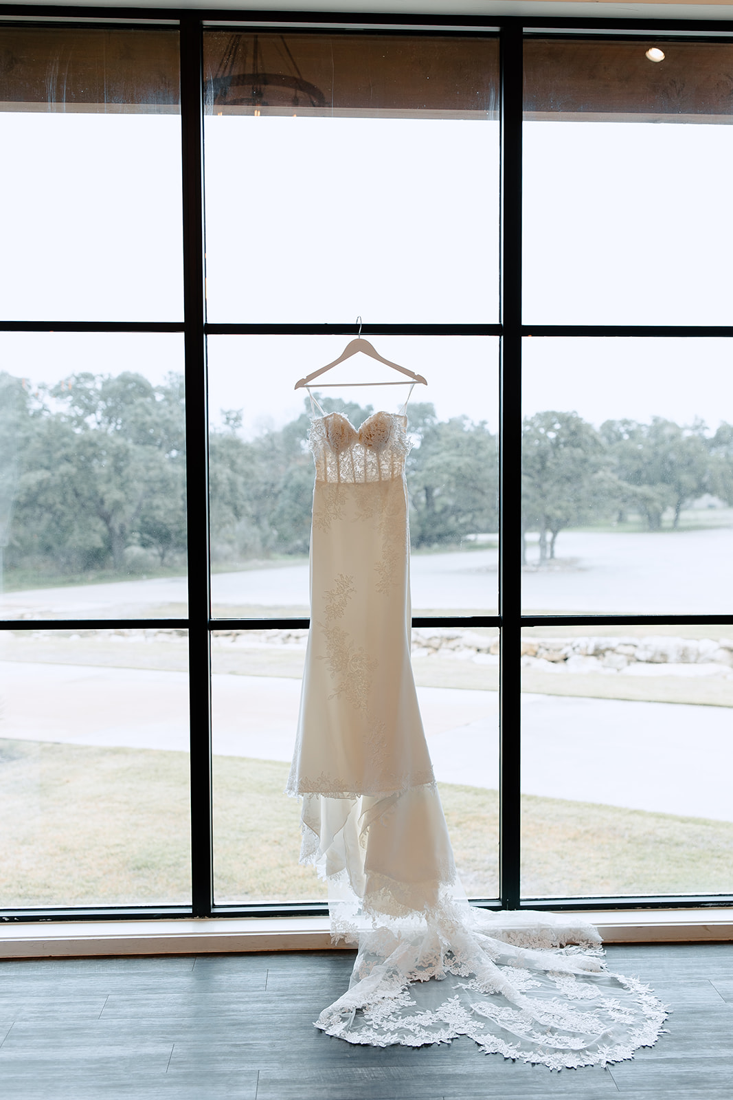 Wedding dress hanging from a window