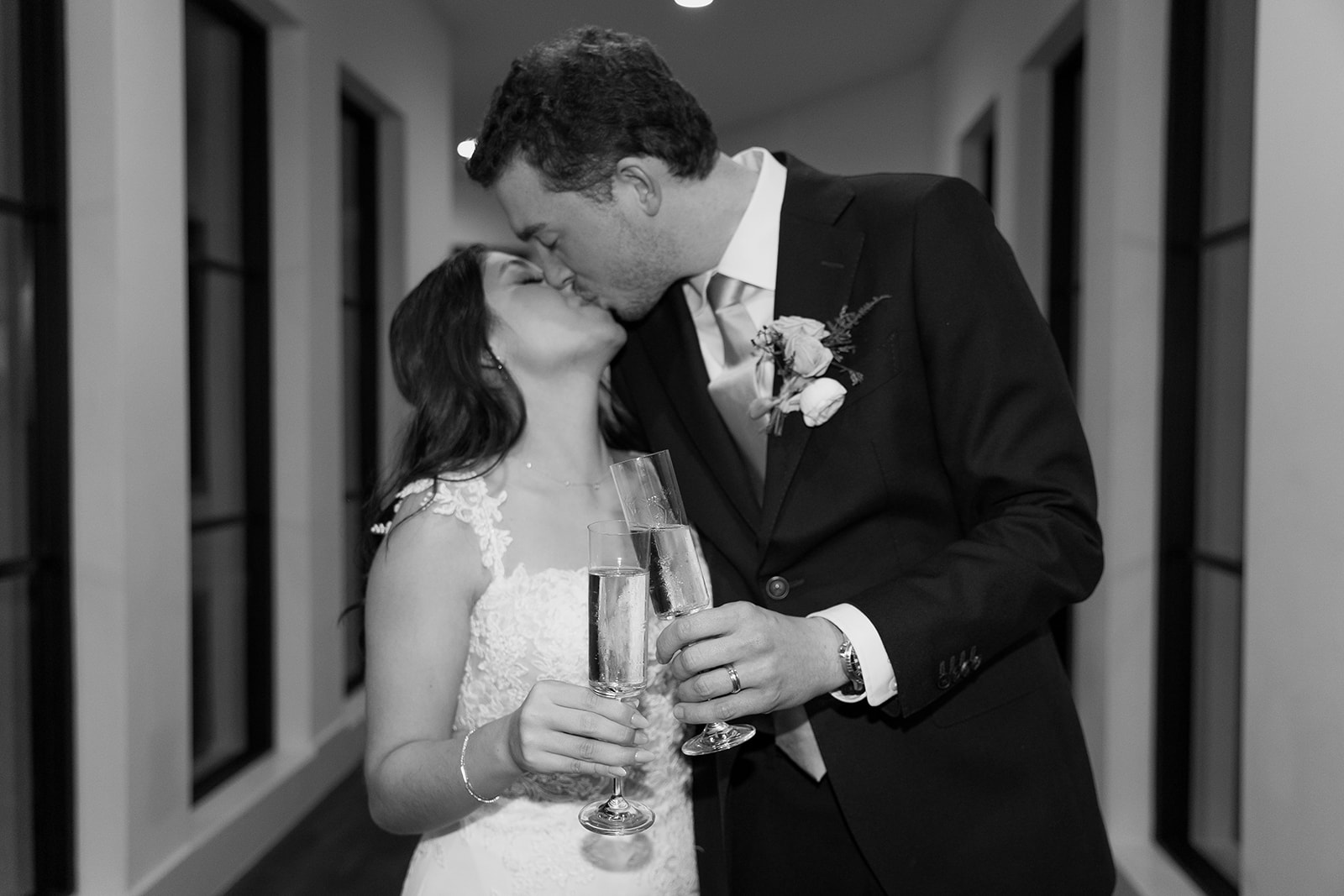 Bride and groom kissing with champagne