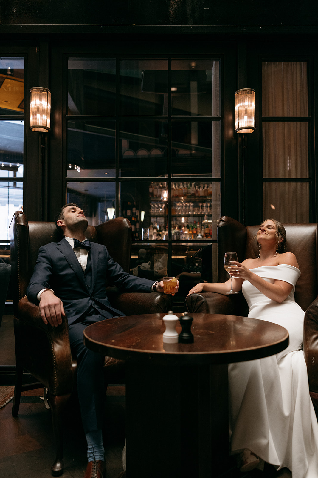 A couple shares drinks on their wedding day at The Roxy Hotel