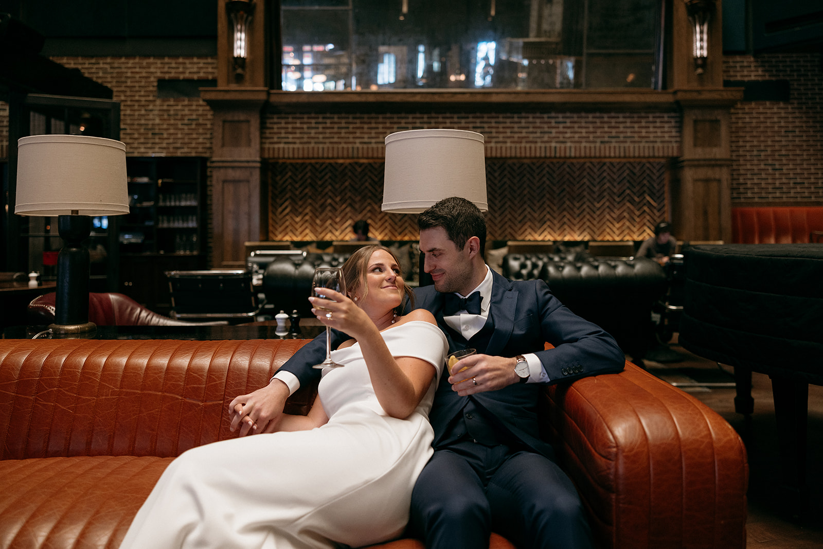A couple shares drinks on their wedding day at The Roxy Hotel