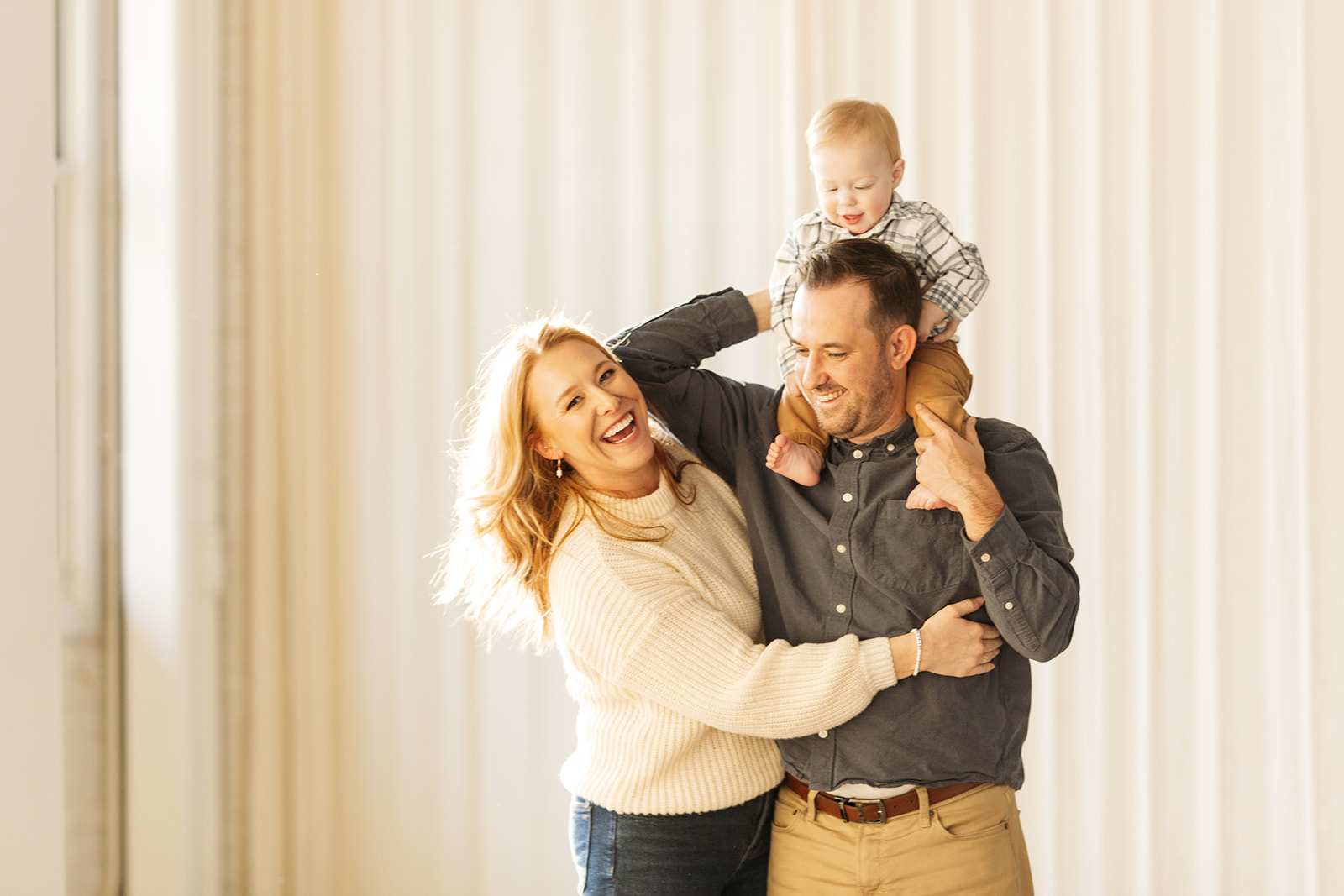 studio family photos with warm neutral outfit tones, small family with baby in denver colorado, family photography inspo