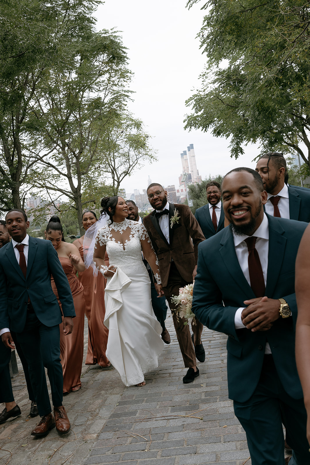 A bride and groom take pictures with their bridal party at Marsha P. Johnson State Park in Brooklyn