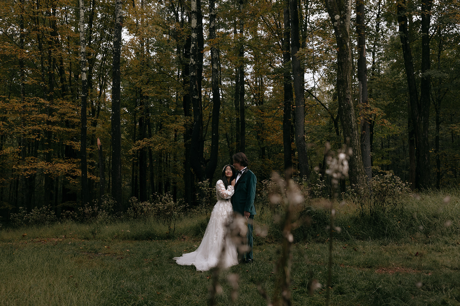 Bride and groom cuddle together during their wedding day at Autocamp Catskills in Upstate New York 