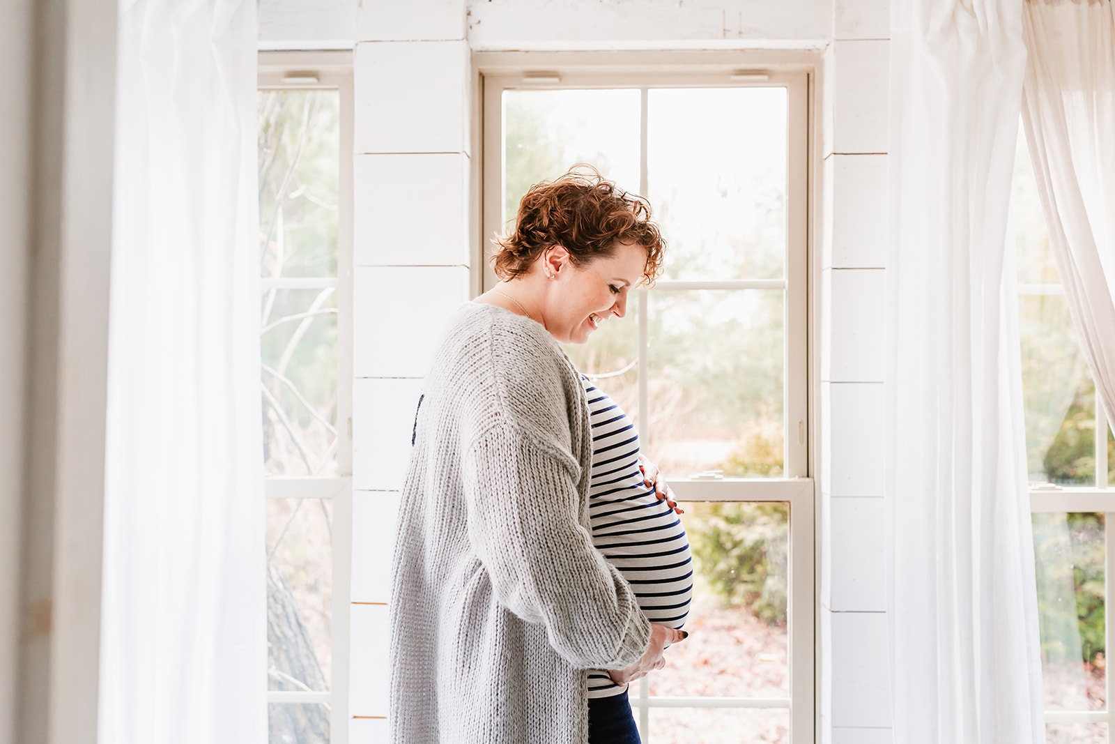 maternity photos in a warm, bright modern farmhouse loft