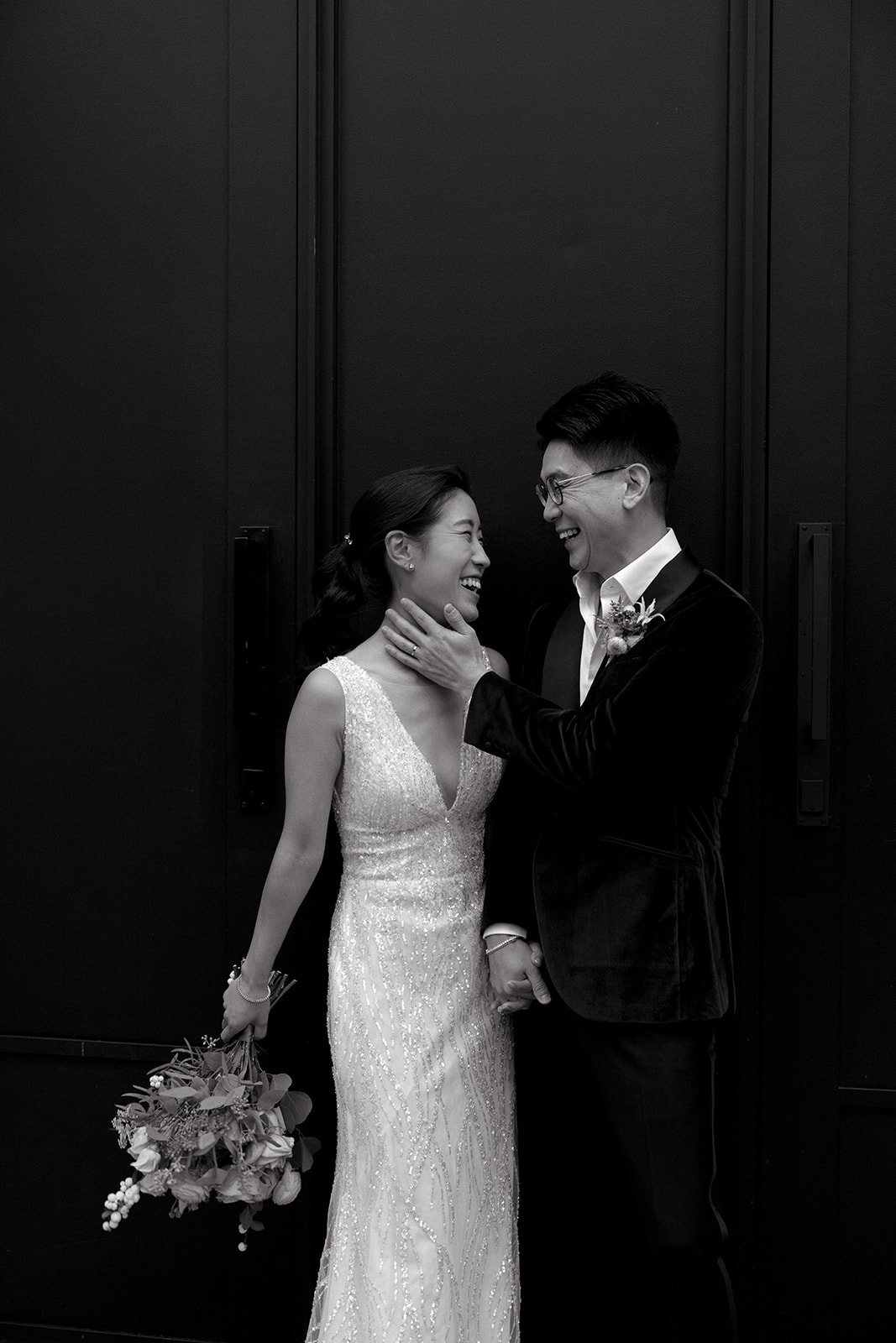 A couple laughs together on their wedding day in Chelsea, NYC