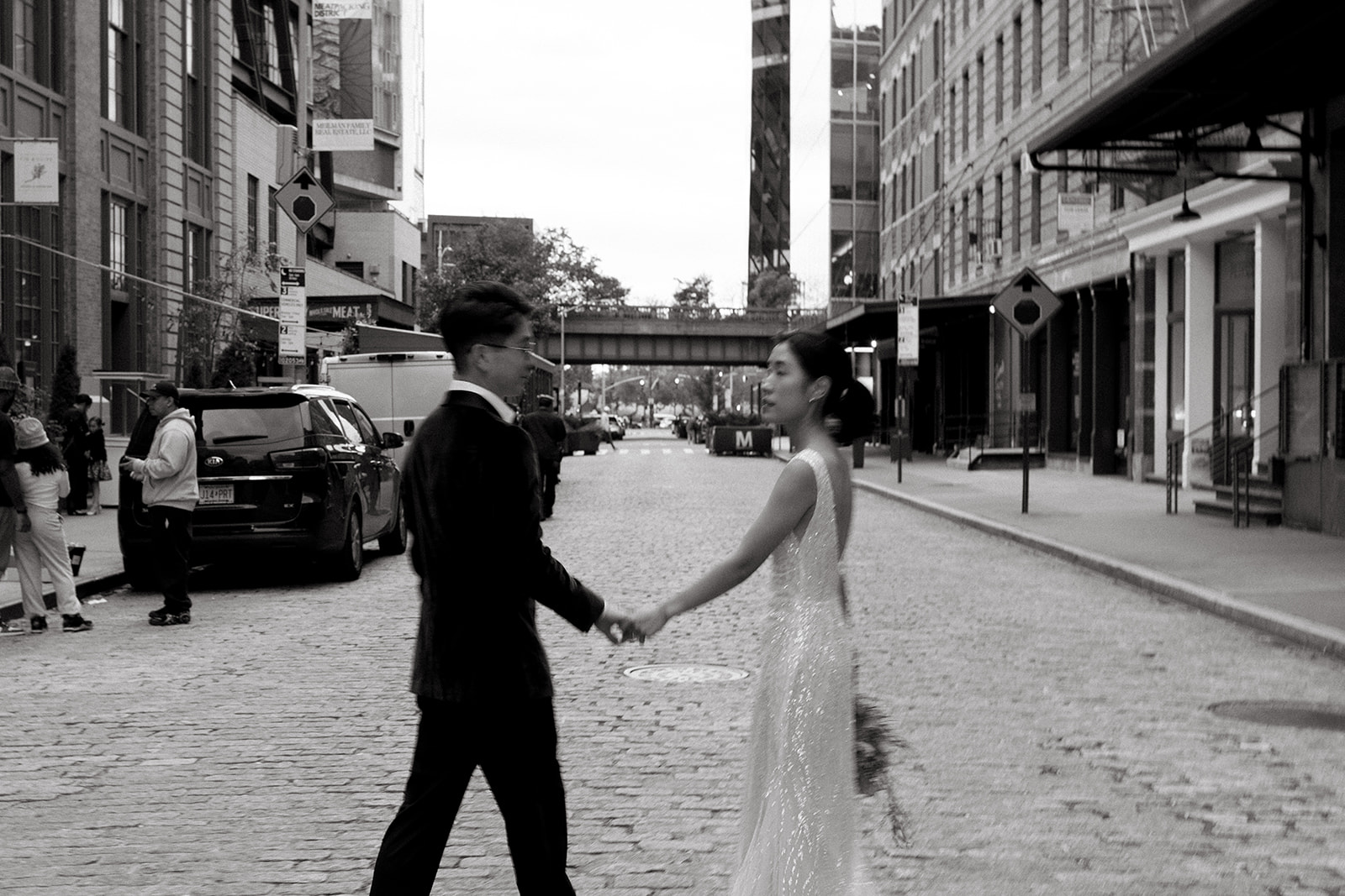 A couple walks together on their wedding day in Chelsea, NYC