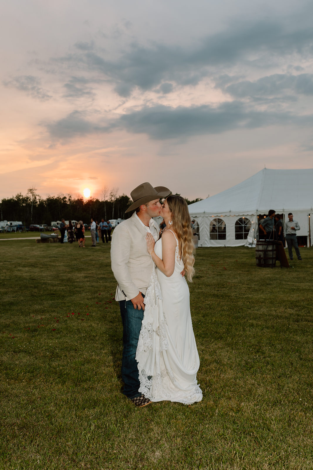 A country couple celebrating their rustic western wedding with their horses