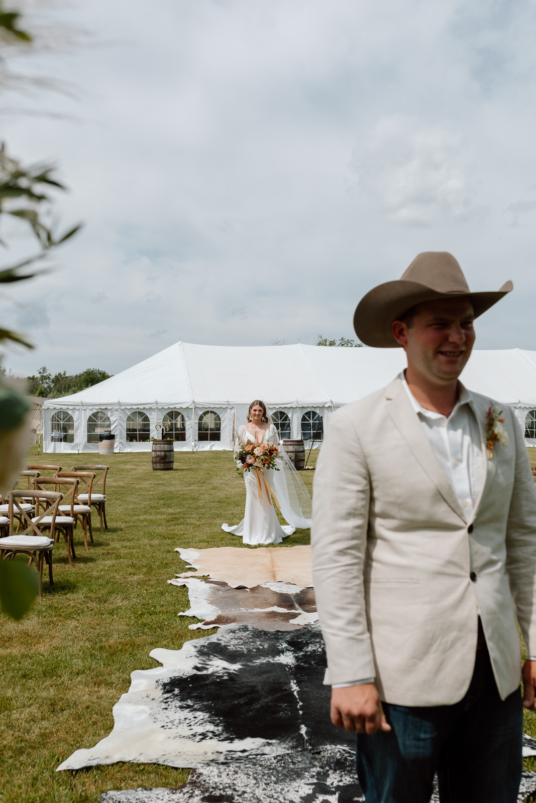 A country couple celebrating their rustic western wedding with their horses