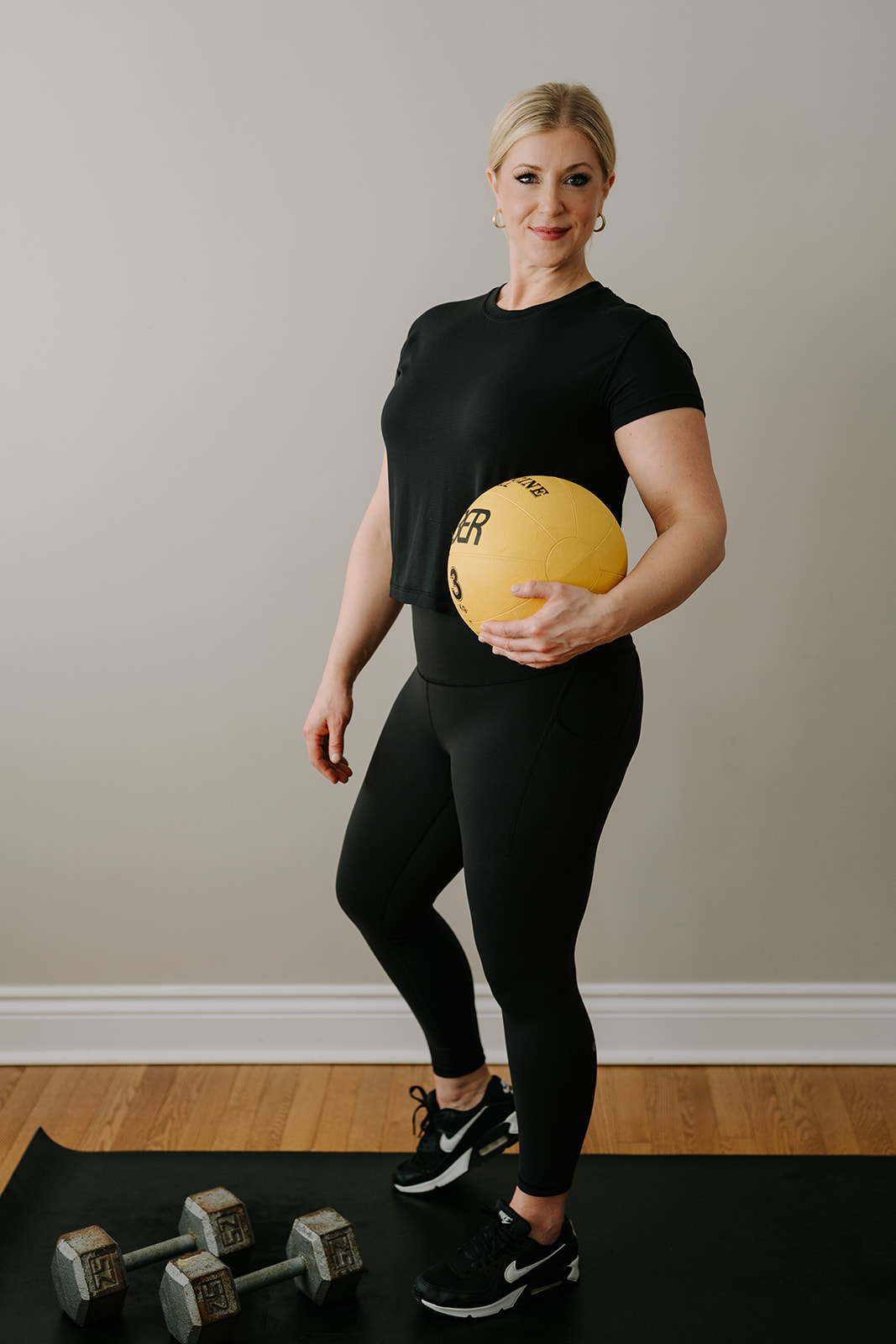 personal trainer with yellow medicine ball
