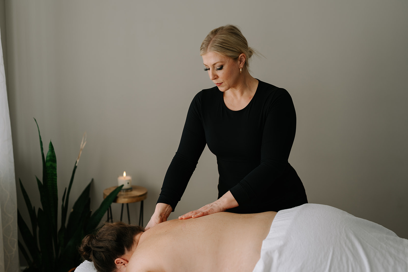 massage therapist giving a back massage