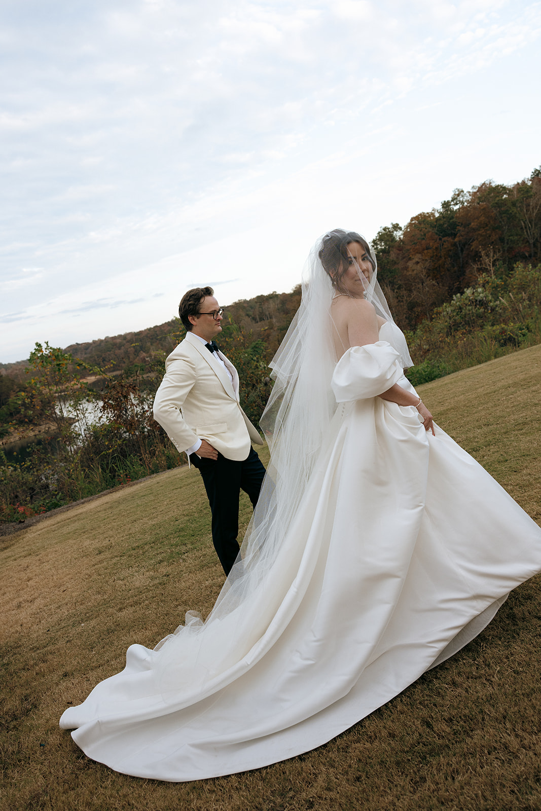 A couple walk together during wedding portraits at The Barn at Smith Lake in Alabama