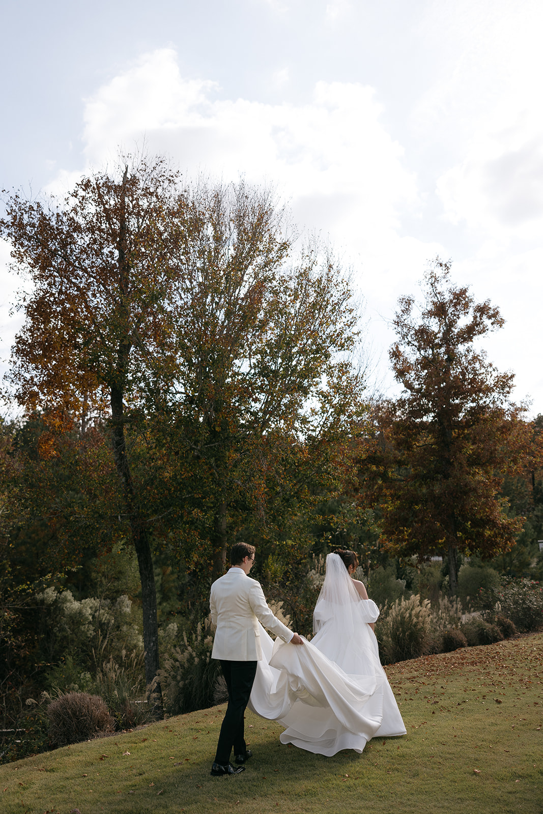 A couple walks during wedding day at The Barn at Smith Lake in Alabama
