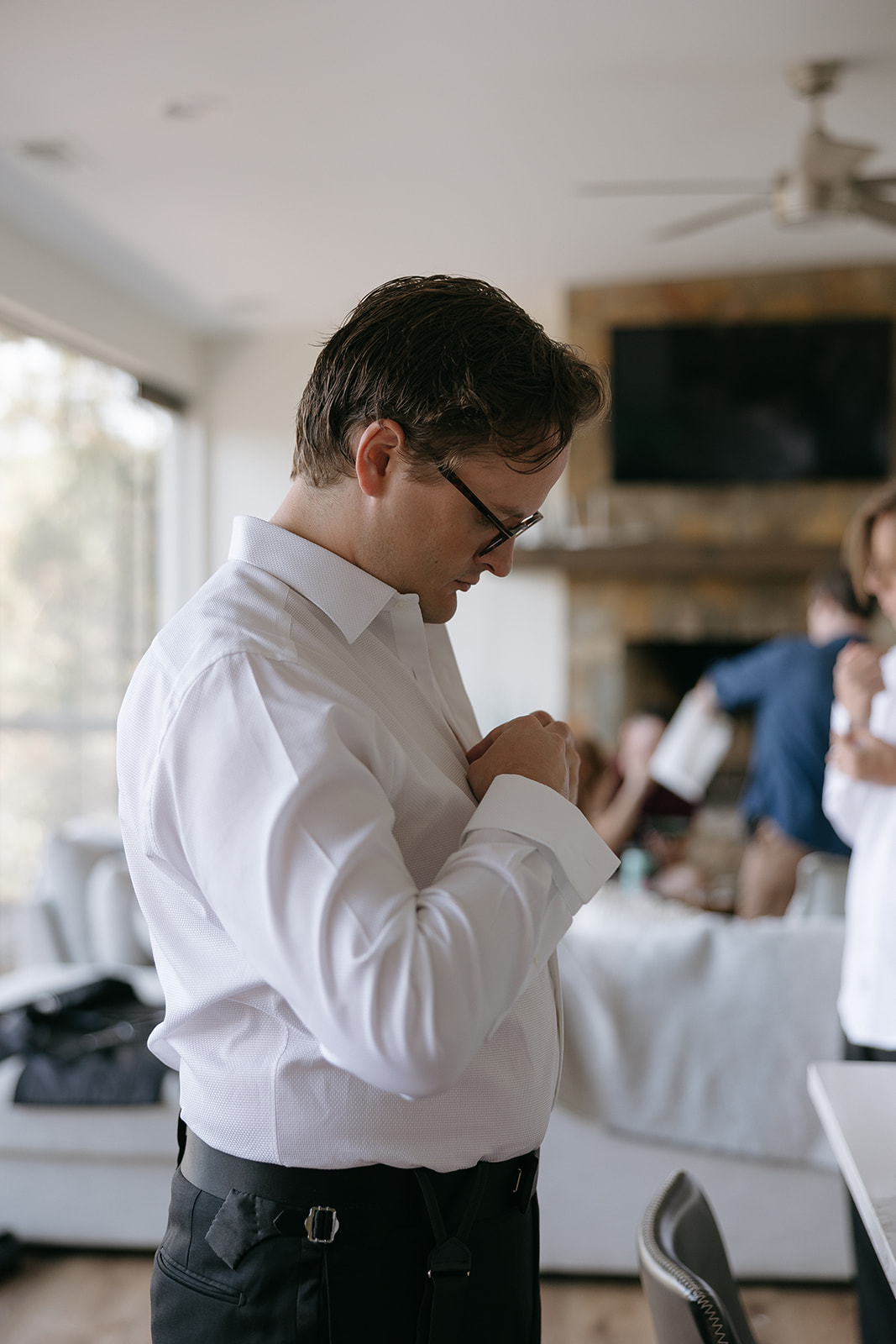 Groom gets ready in suite at The Barn at Smith Lake on wedding day in Alabama