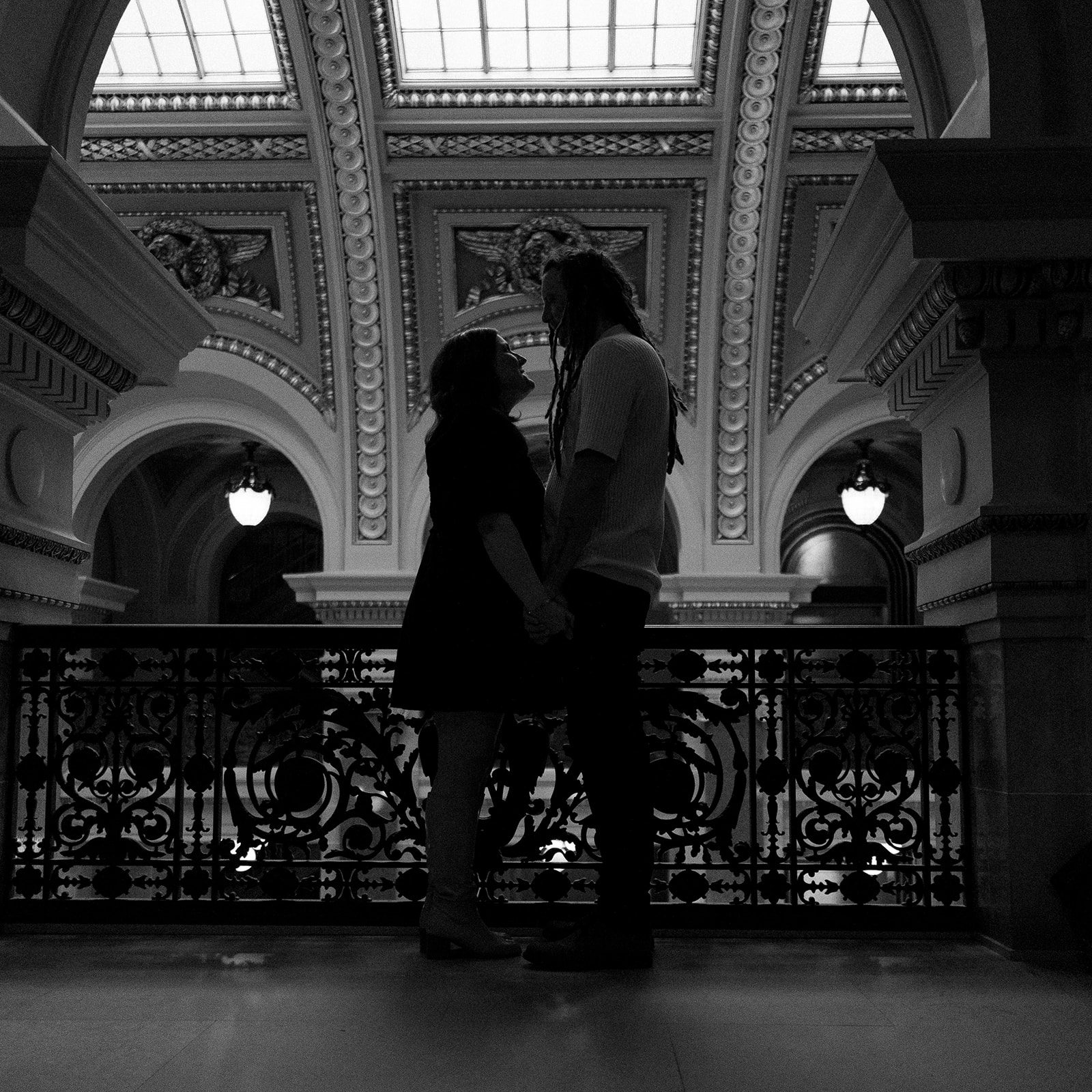 an engaged couple embraces in the Wisconsin State Capitol building in Madison