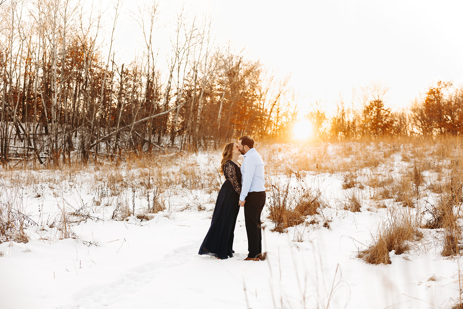 Man and woman kissing in the snow.