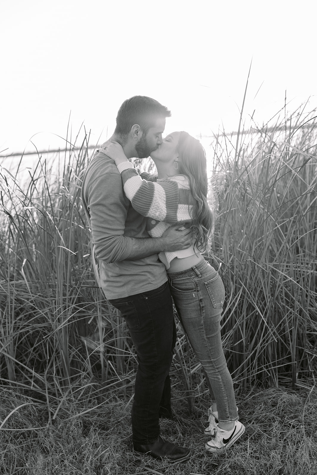 couple kissing in front of Lake Bryan near College Station, Texas