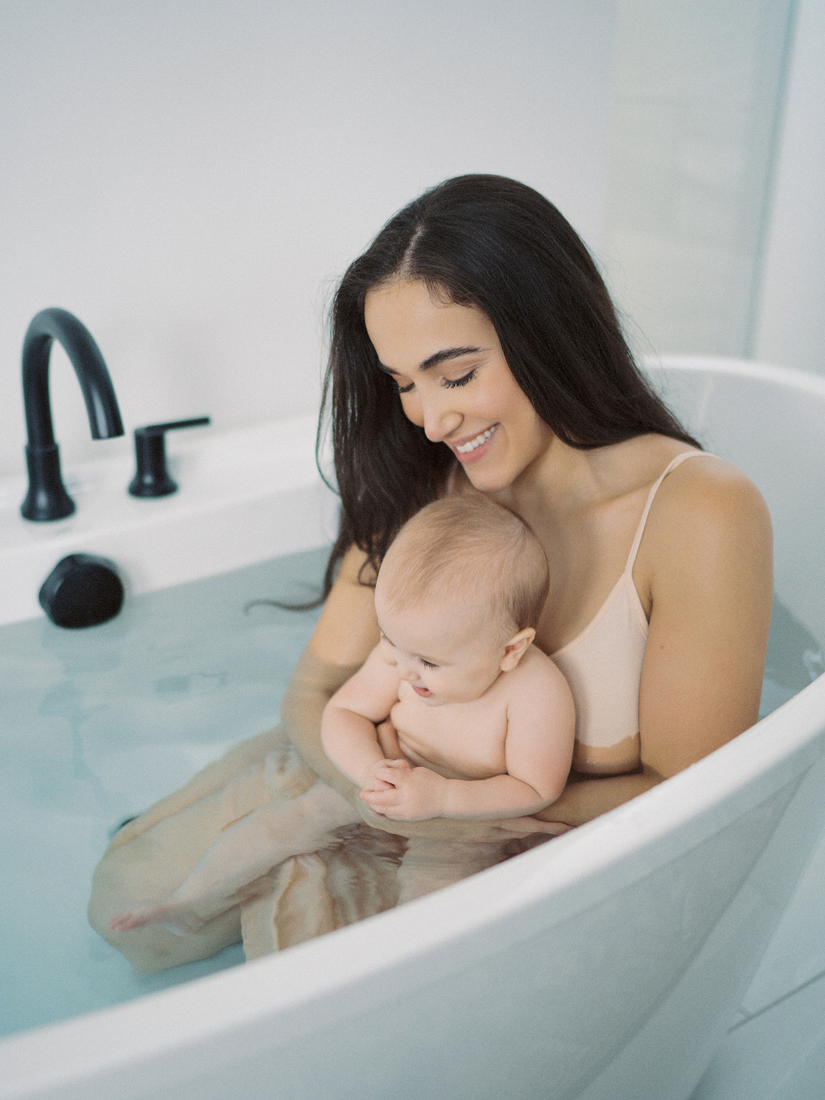mother and baby in a bathtub studio photo session boise idaho