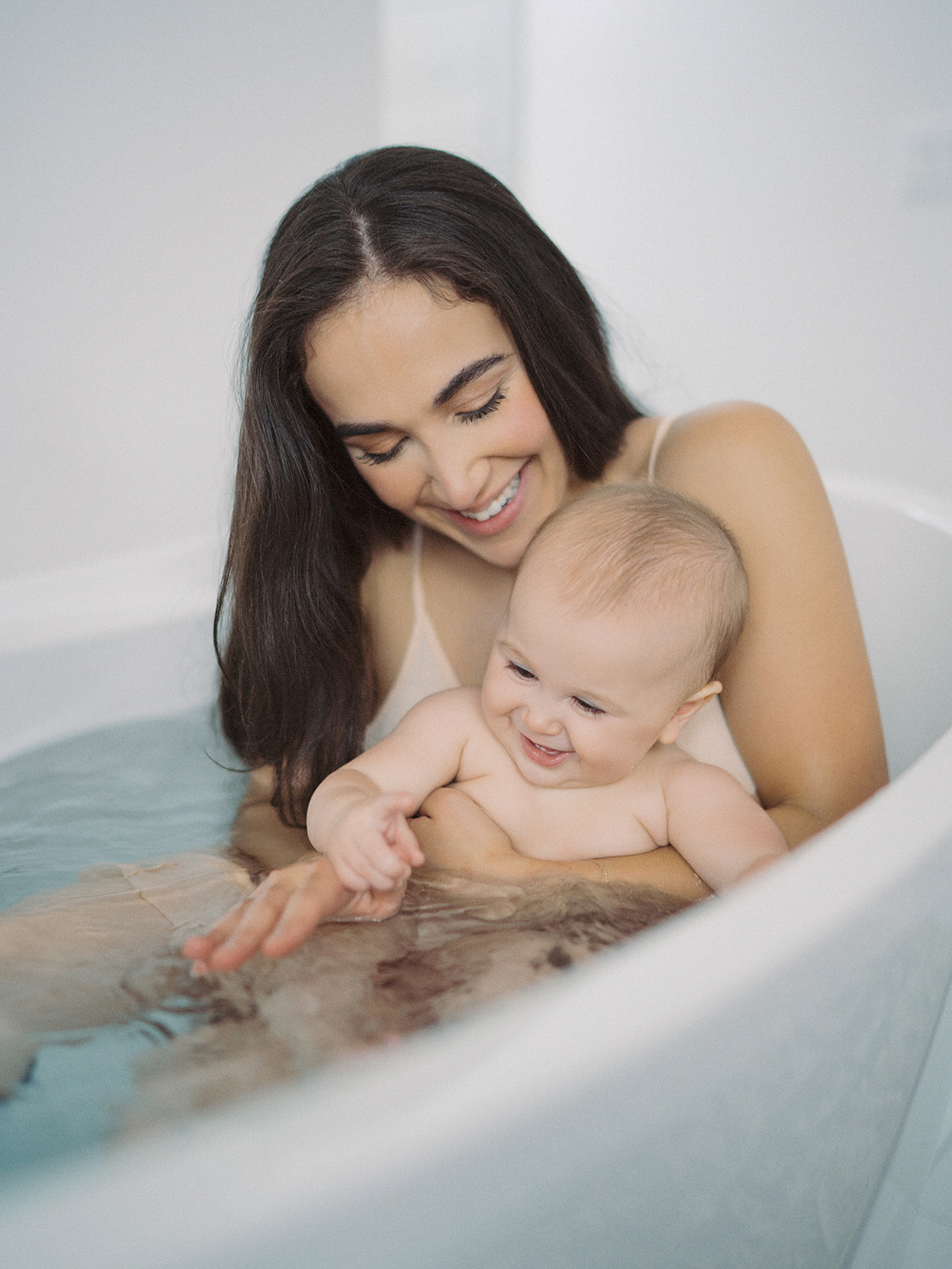 mother and baby in a bathtub studio photo session boise idaho