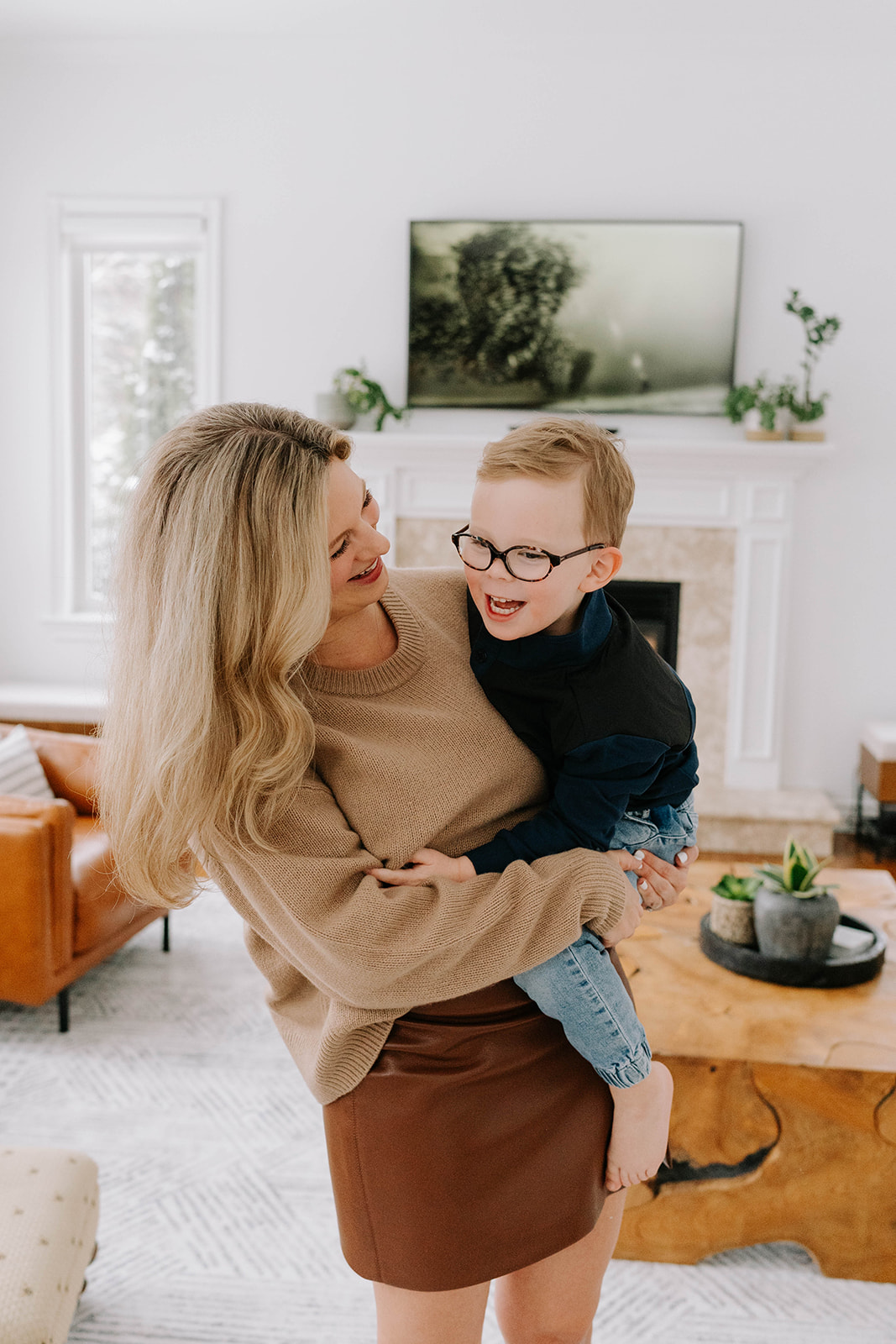 mother and son laughing in living room