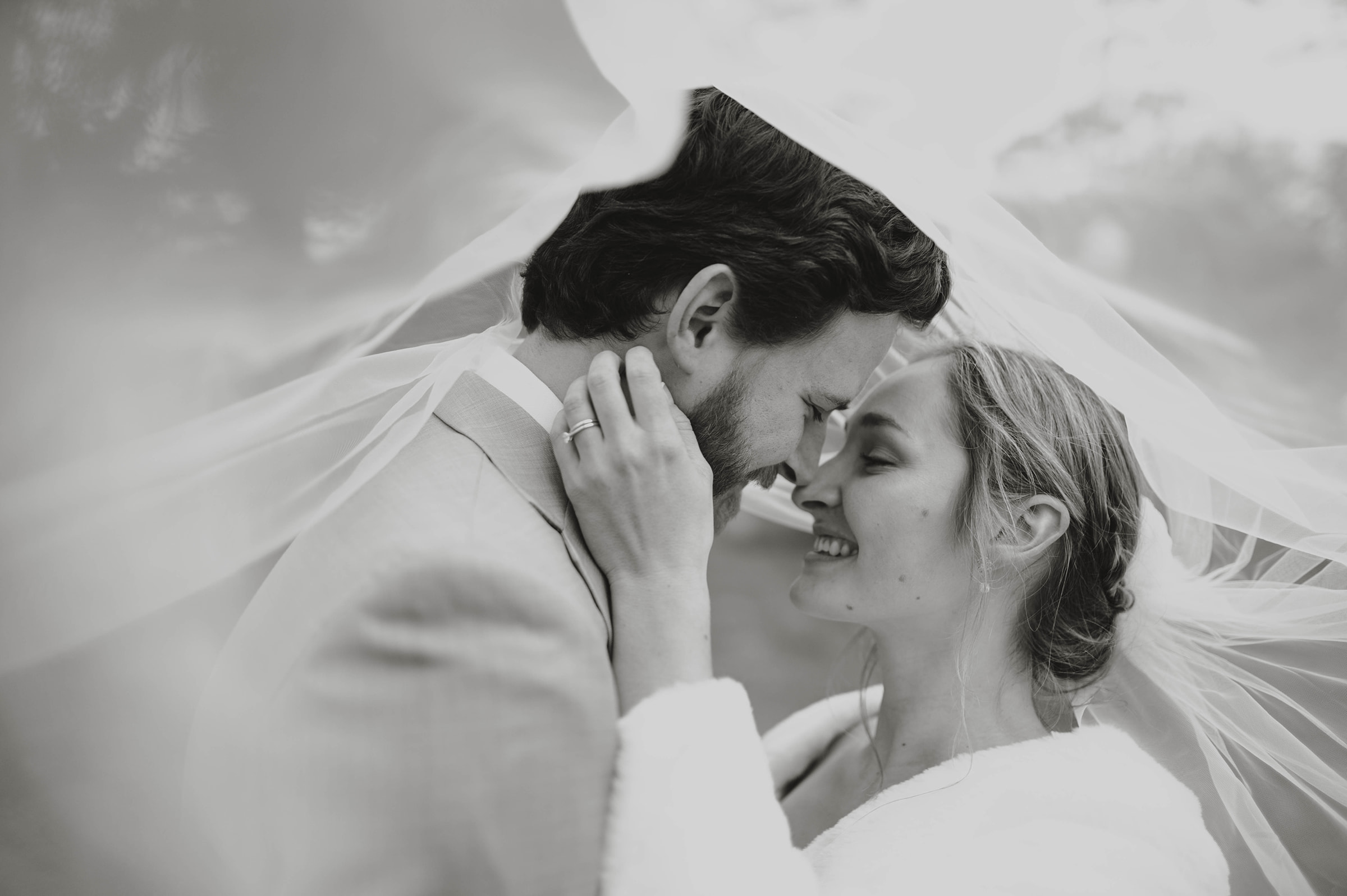 a couple under a veil michigan wedding photographer