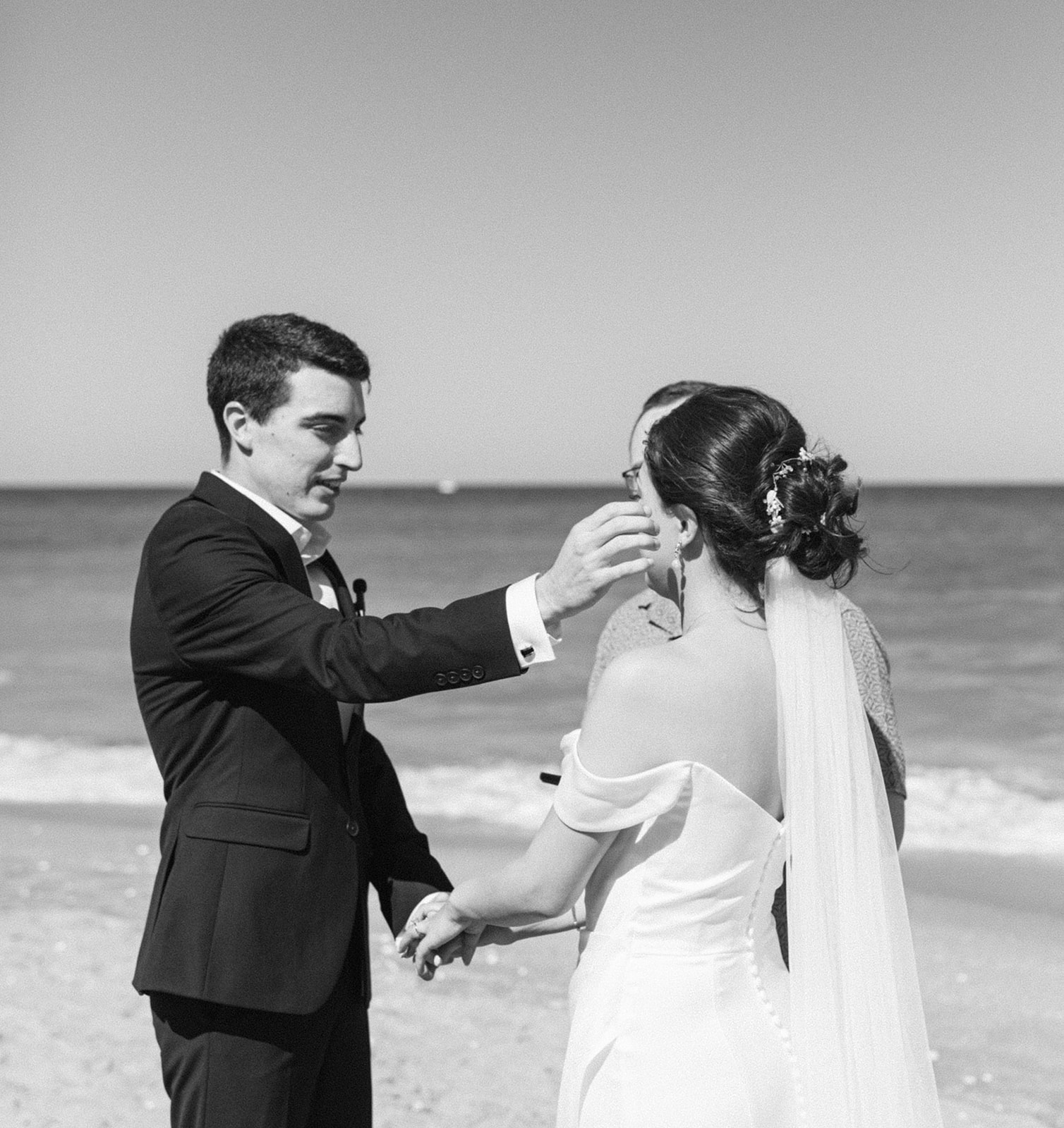 Groom fixes brides hair at emotional Palm Beach, Florida wedding ceremony