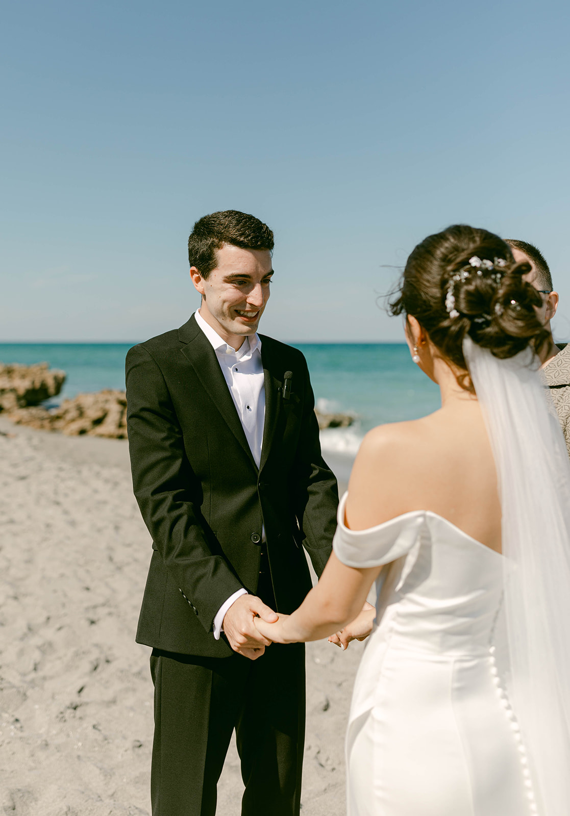 Groom smiles at bride during Palm Beach, Florida intimate wedding ceremony