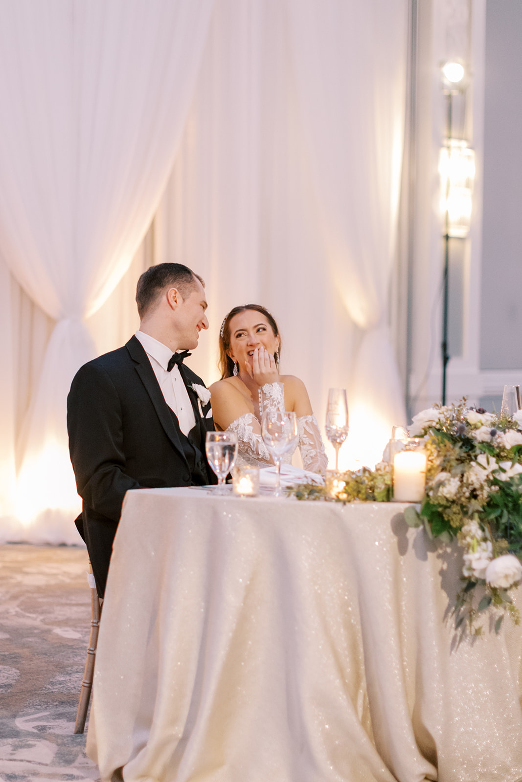Bride and groom laugh during toasts at Lansdowne resort wedding