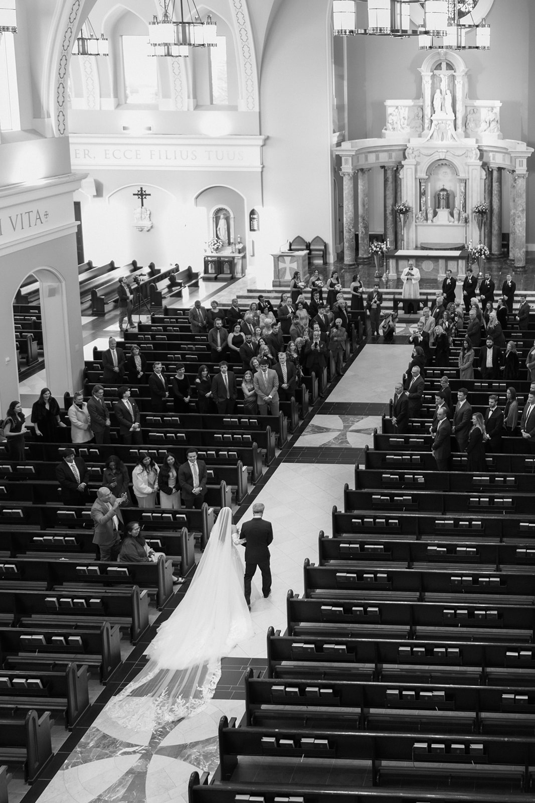 A view from the choir loft of the bride walking down the aisle at the gorgeous St Johns Leesburg