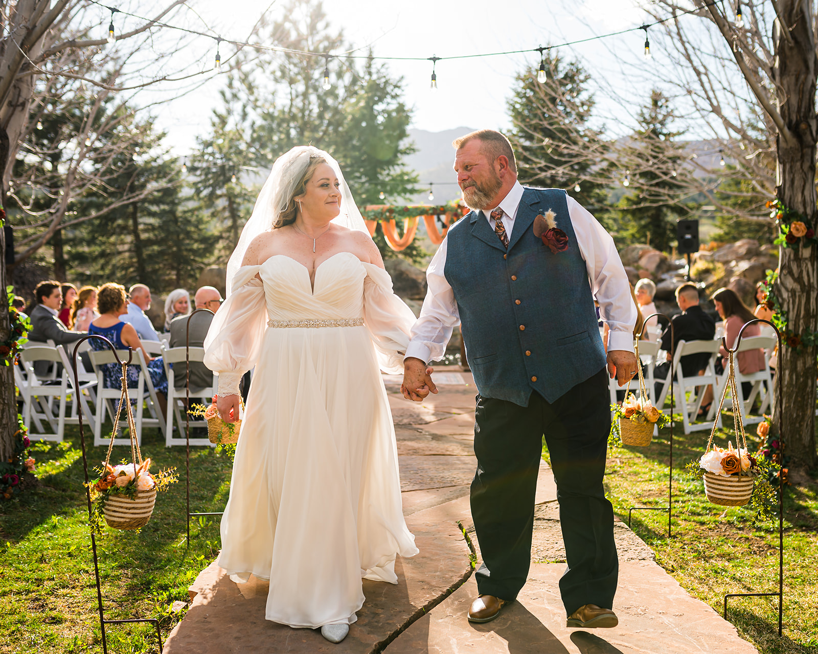 Bride and groom walking down isle at ceremony Greenbriar Inn Boulder Colorado wedding photographer