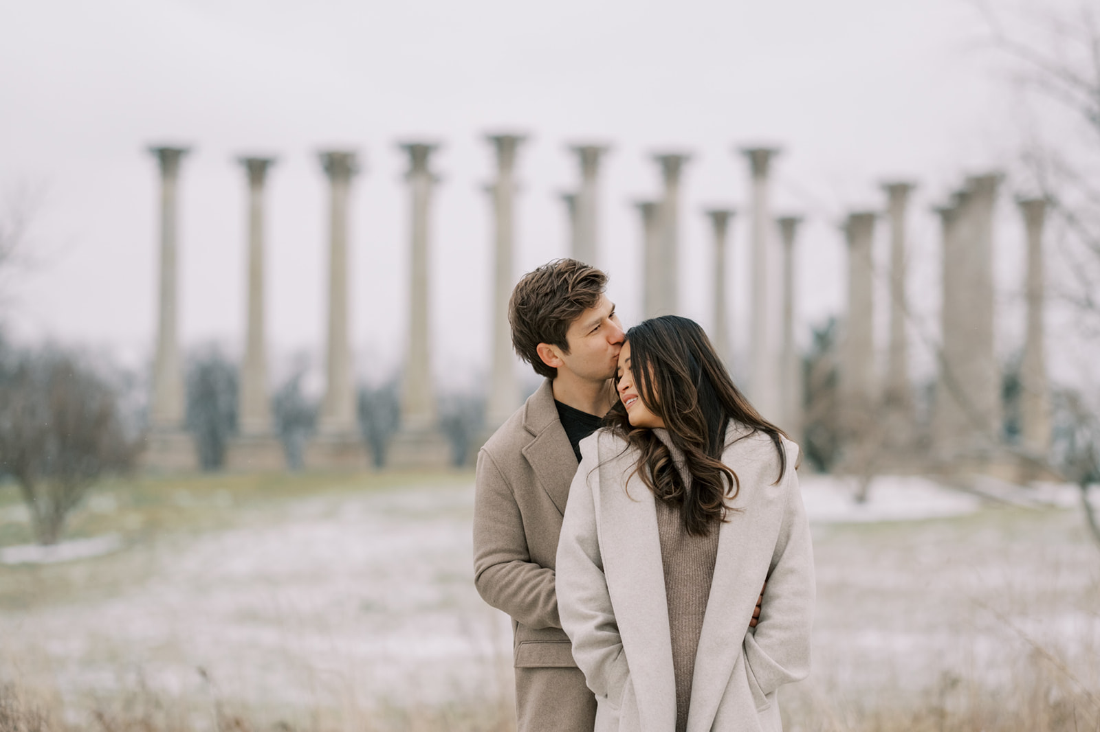 Couple poses for engagement photos in front of the National Arboretum columns