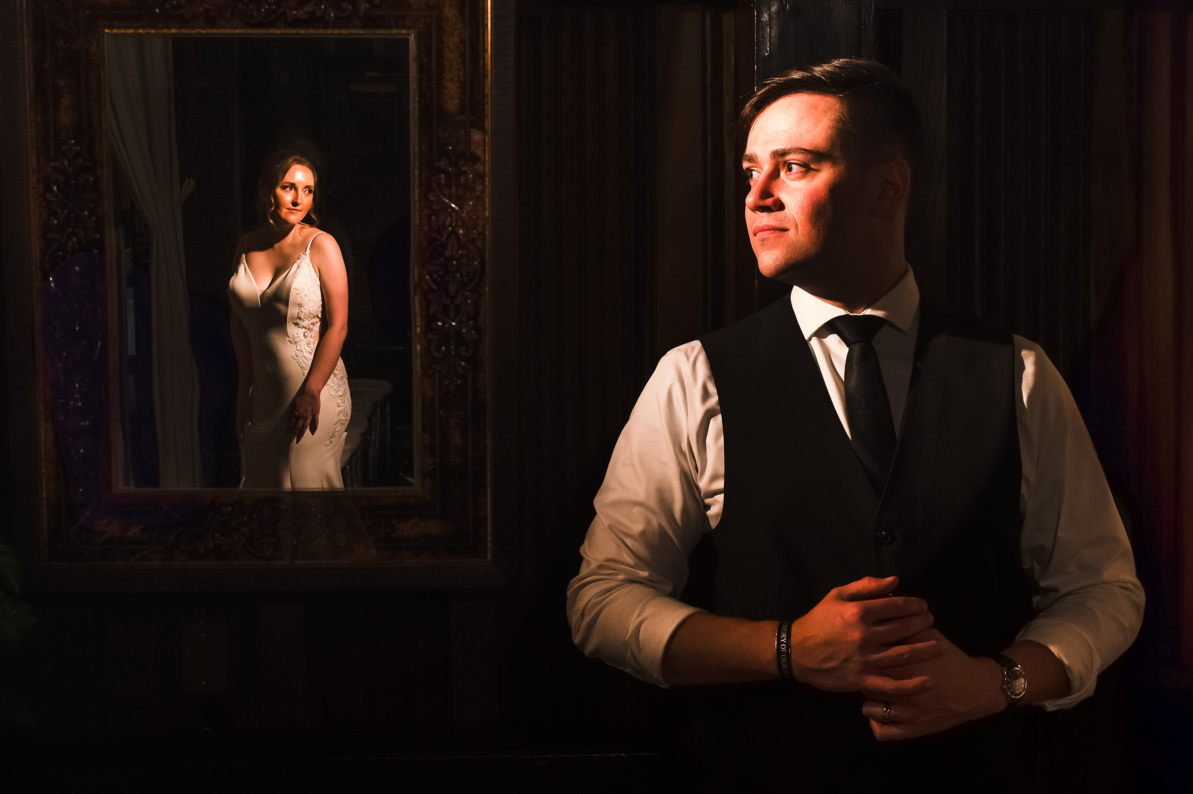 Wellshire event center dramatic epic wedding couple portrait Bride in mirror with groom looking at her dark and moody