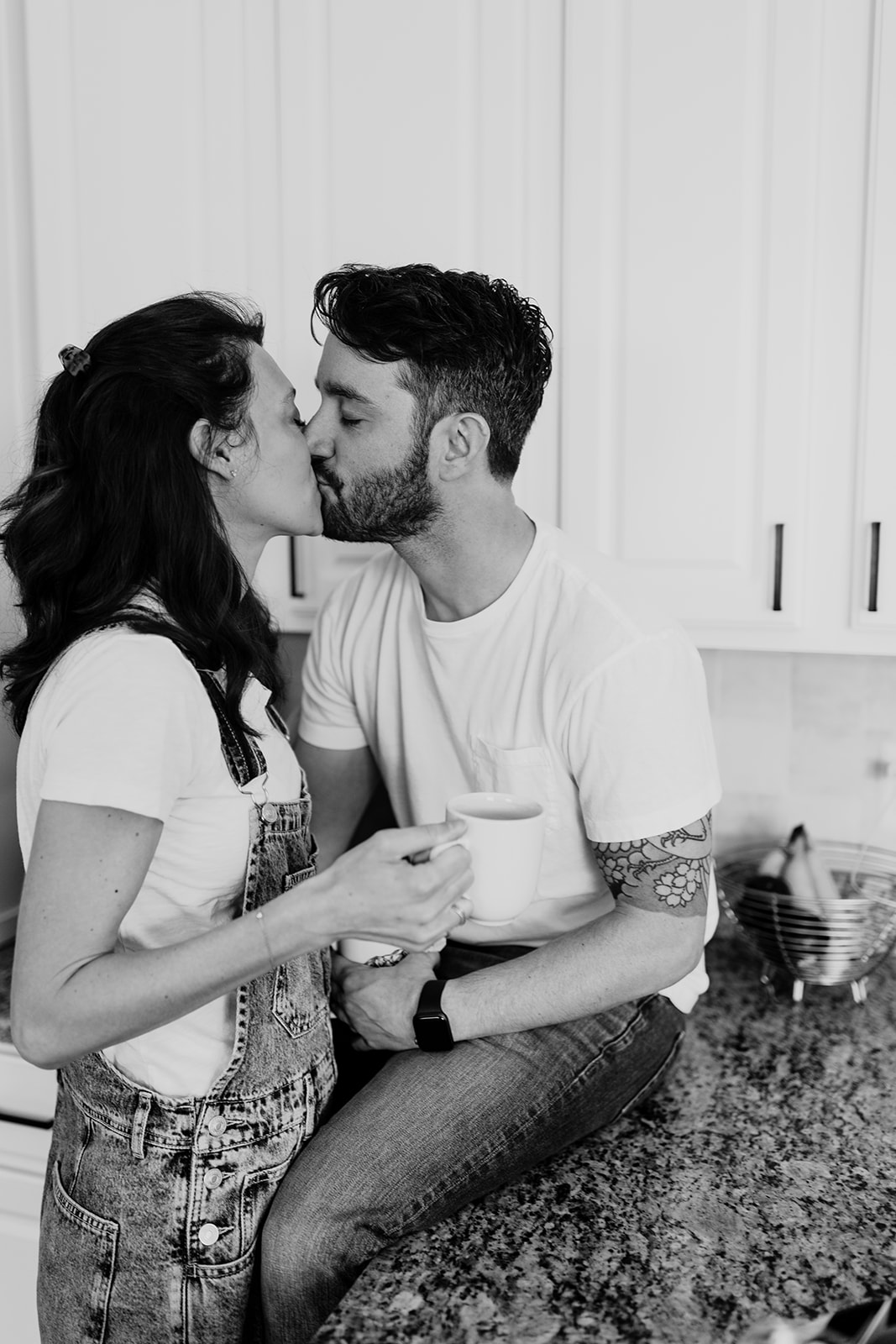 couple kissing in kitchen