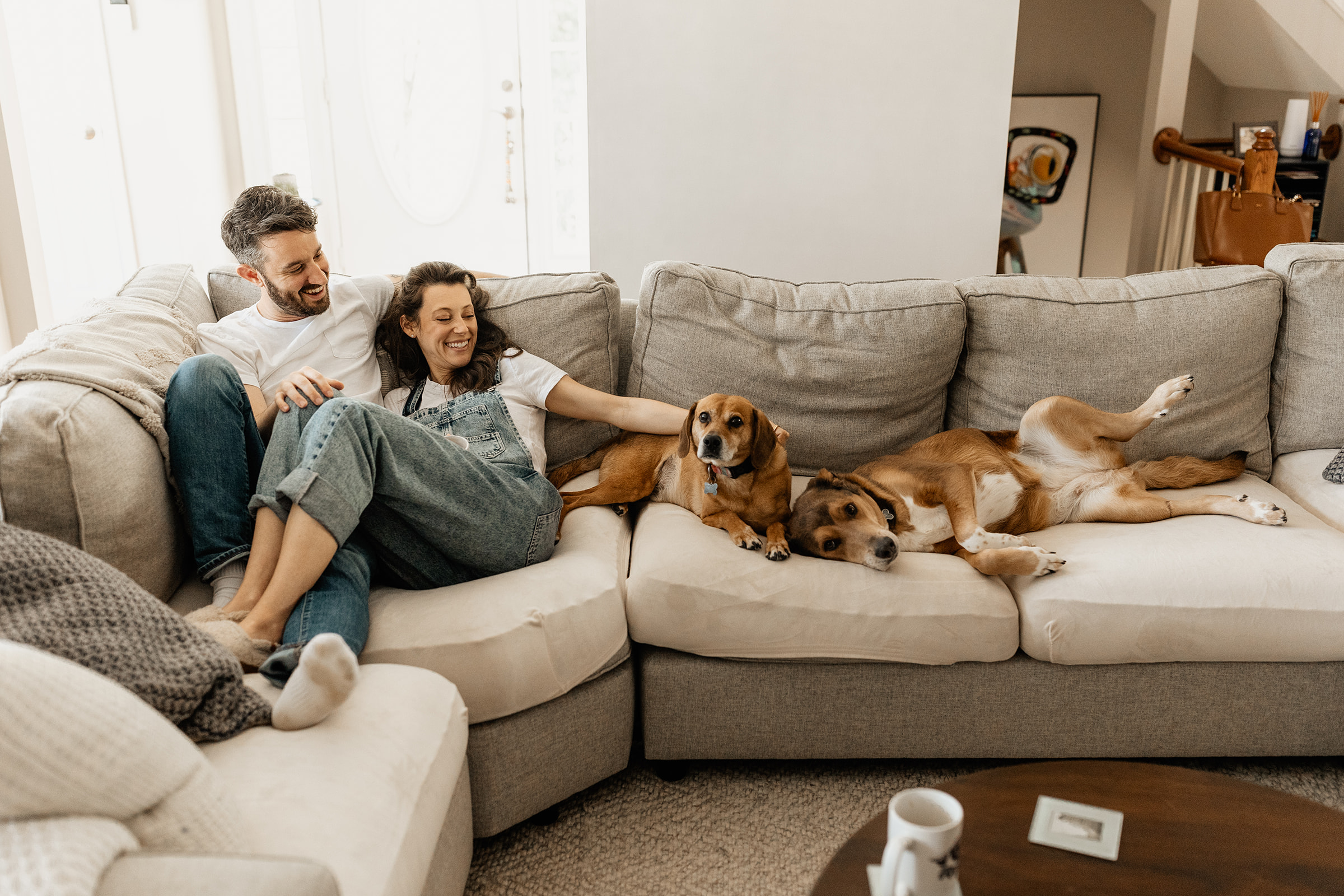 couple on the couch with their dogs